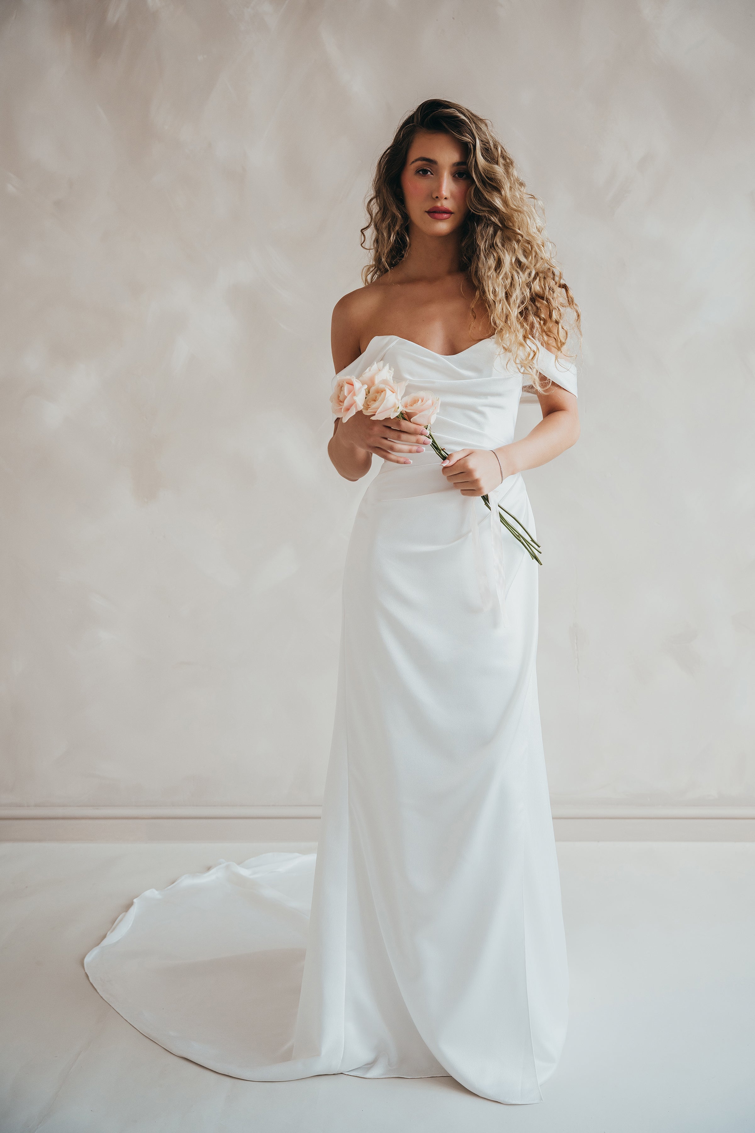Bride wearing the Pearl satin wedding dress with sweetheart neckline and bardot sleeves.