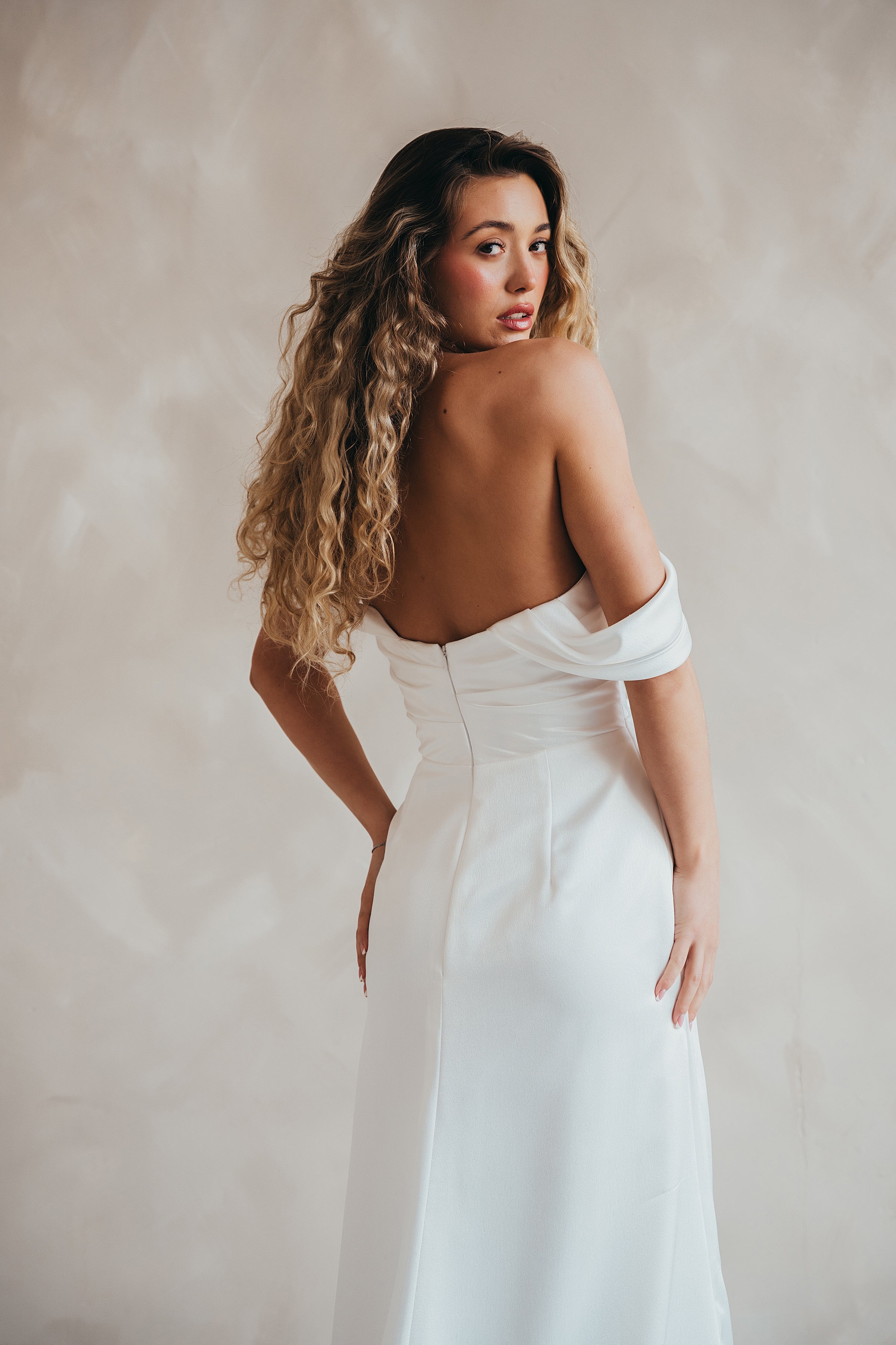 Bride wearing the Pearl satin wedding dress with sweetheart neckline and bardot sleeves.