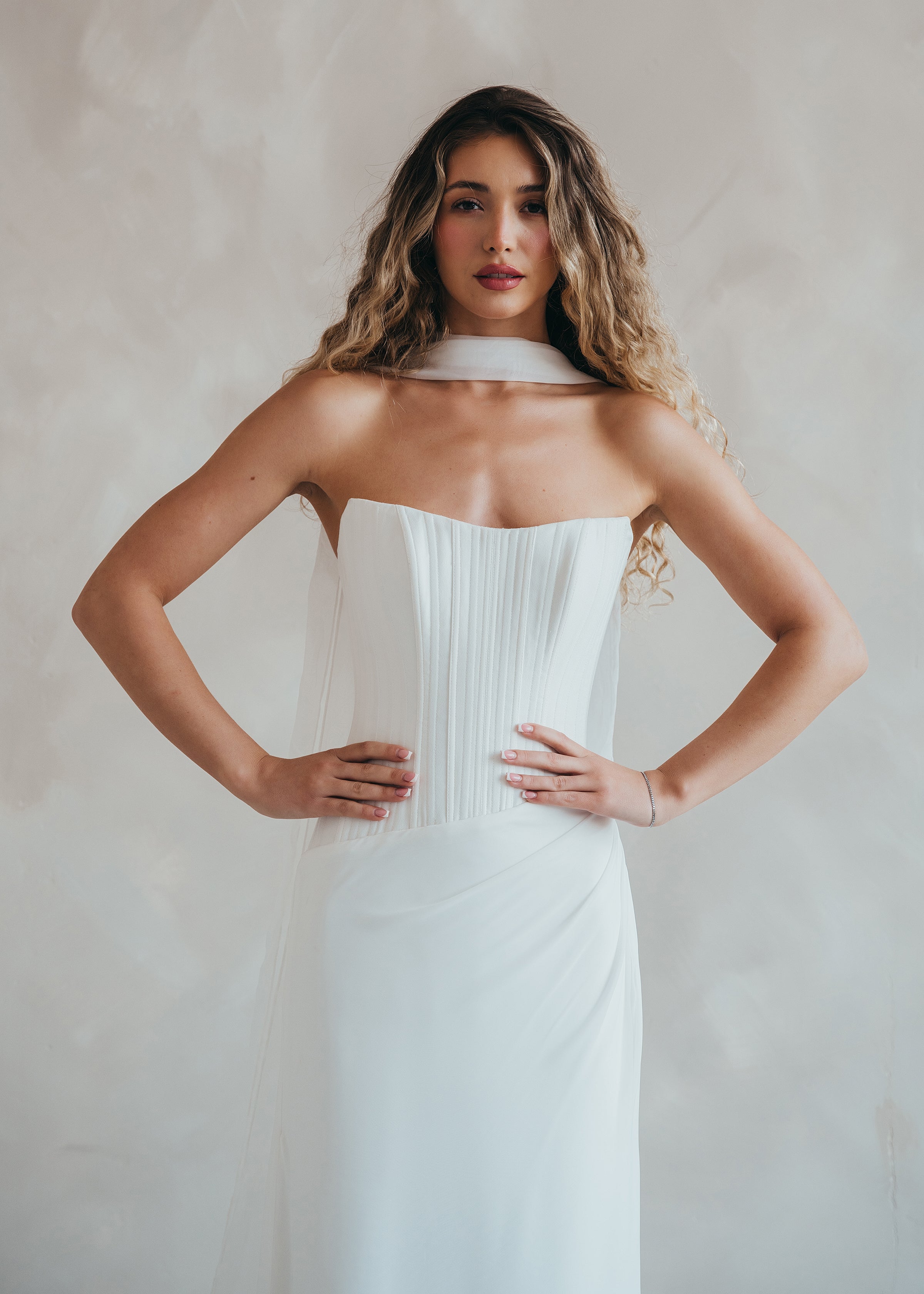 Bride wearing the Portia wedding dress with structured crepe bodice and flowing chiffon skirt.