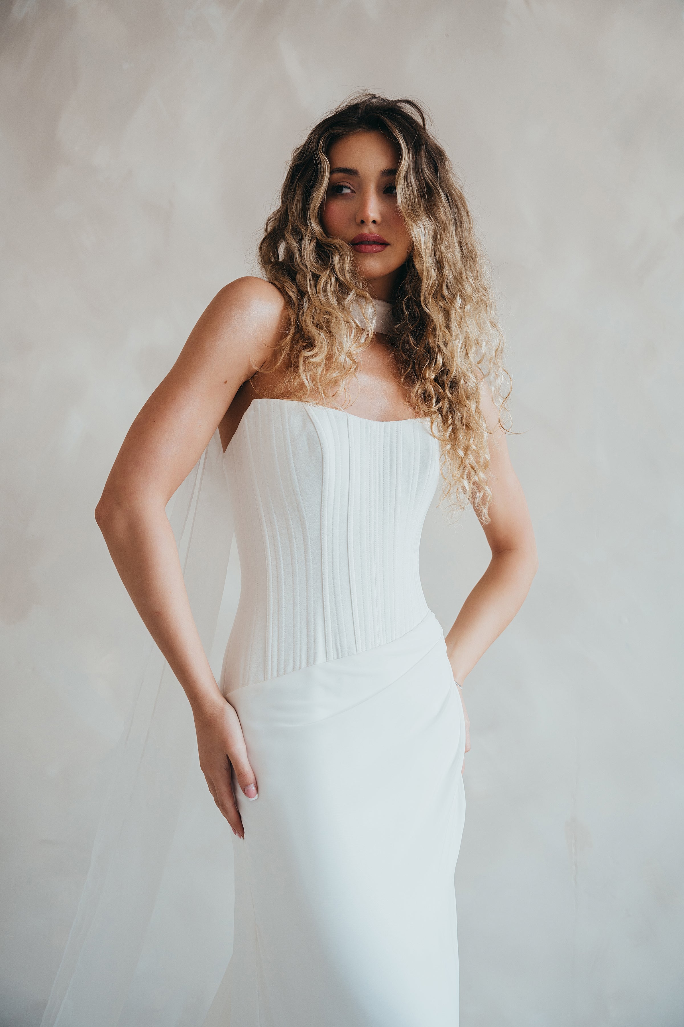 Bride wearing the Portia wedding dress with structured crepe bodice and flowing chiffon skirt.