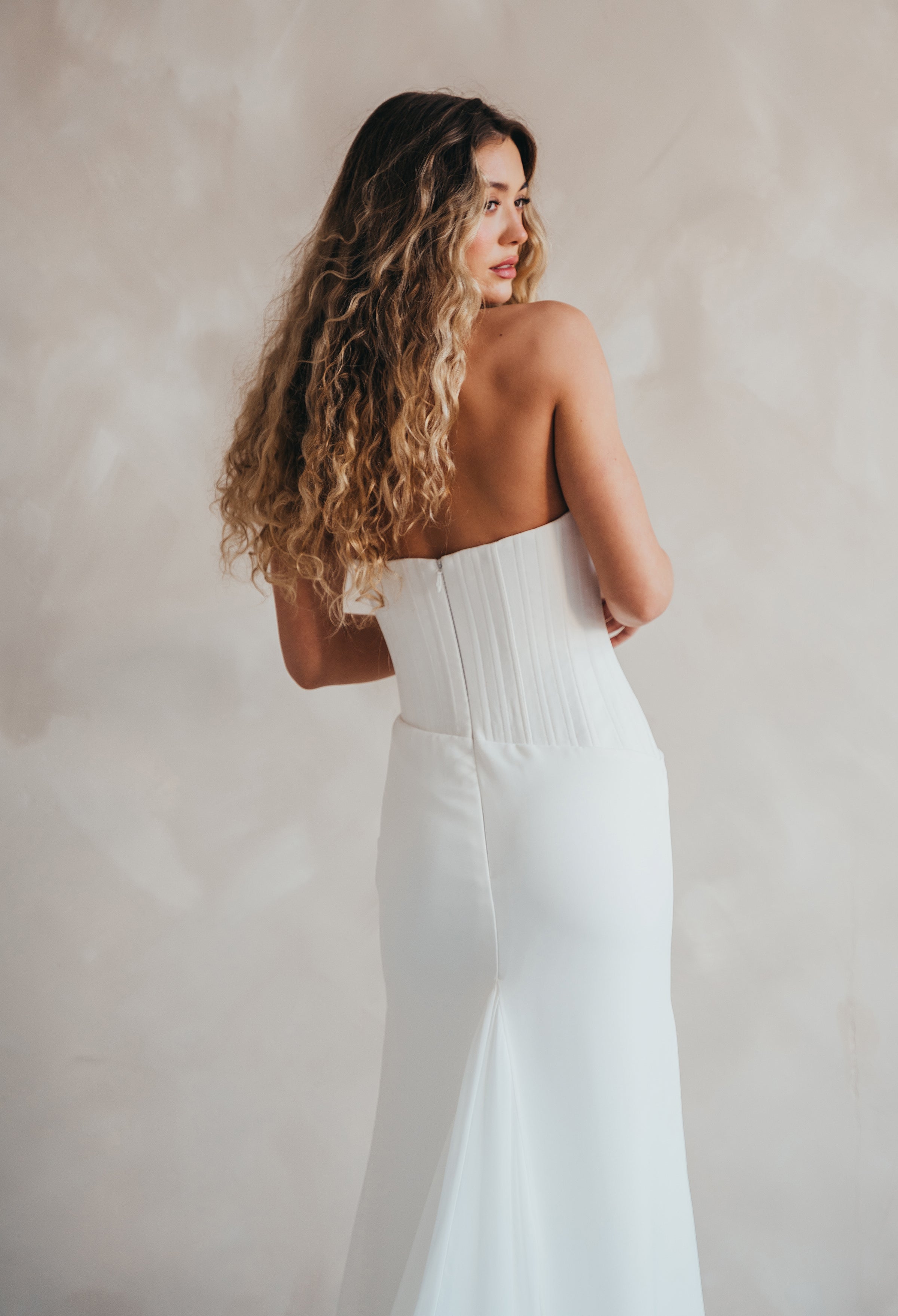 Bride wearing the Portia wedding dress with structured crepe bodice and flowing chiffon skirt.