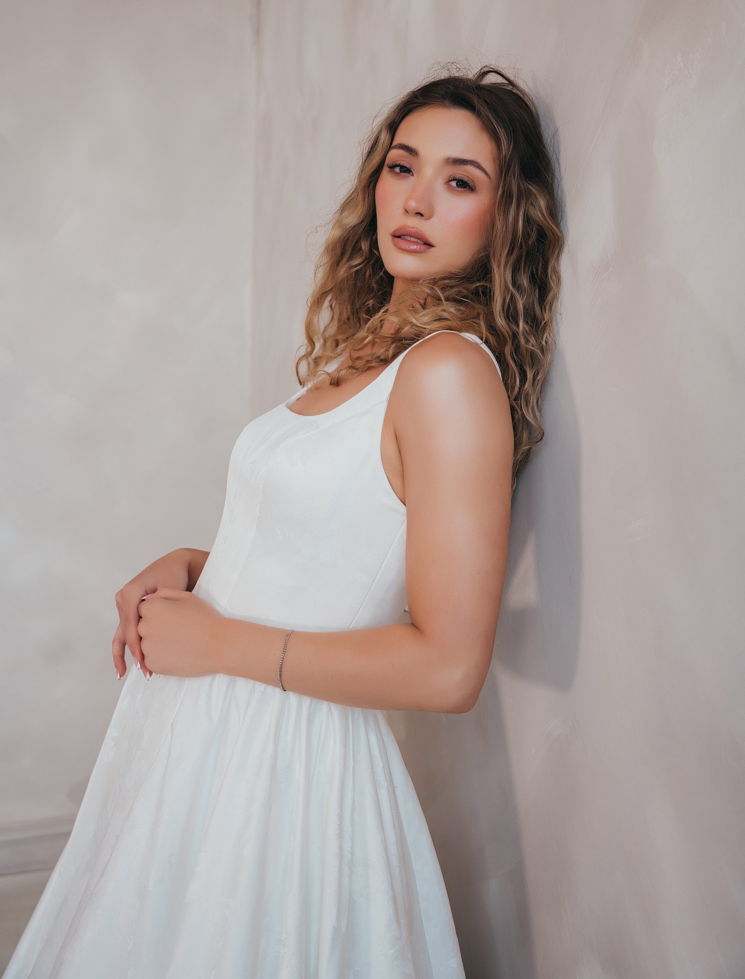 Bride wearing the Blossom floral satin A-line wedding dress with square neckline.