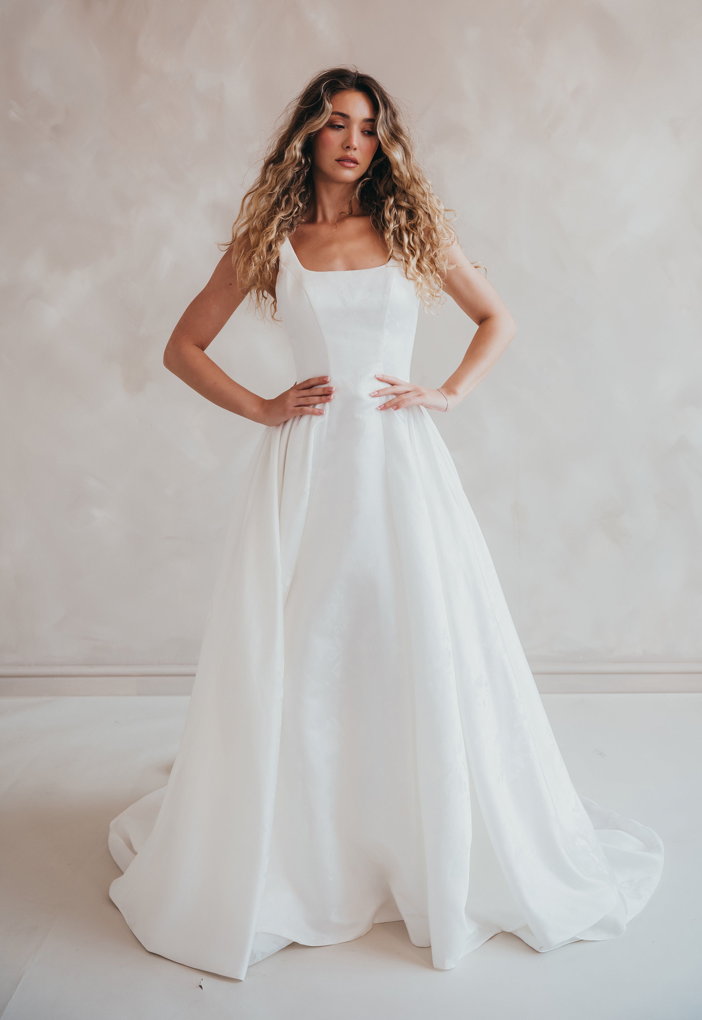 Bride wearing the Blossom floral satin A-line wedding dress with square neckline.