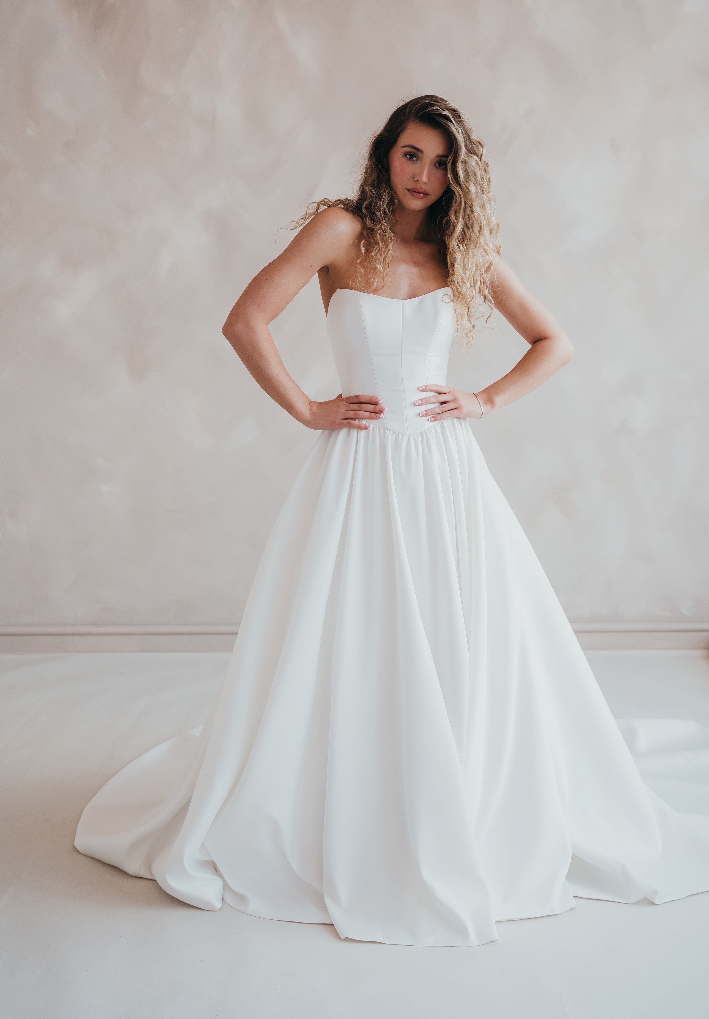 Bride wearing the Lua strapless Mikado wedding dress with pleated A-line skirt.