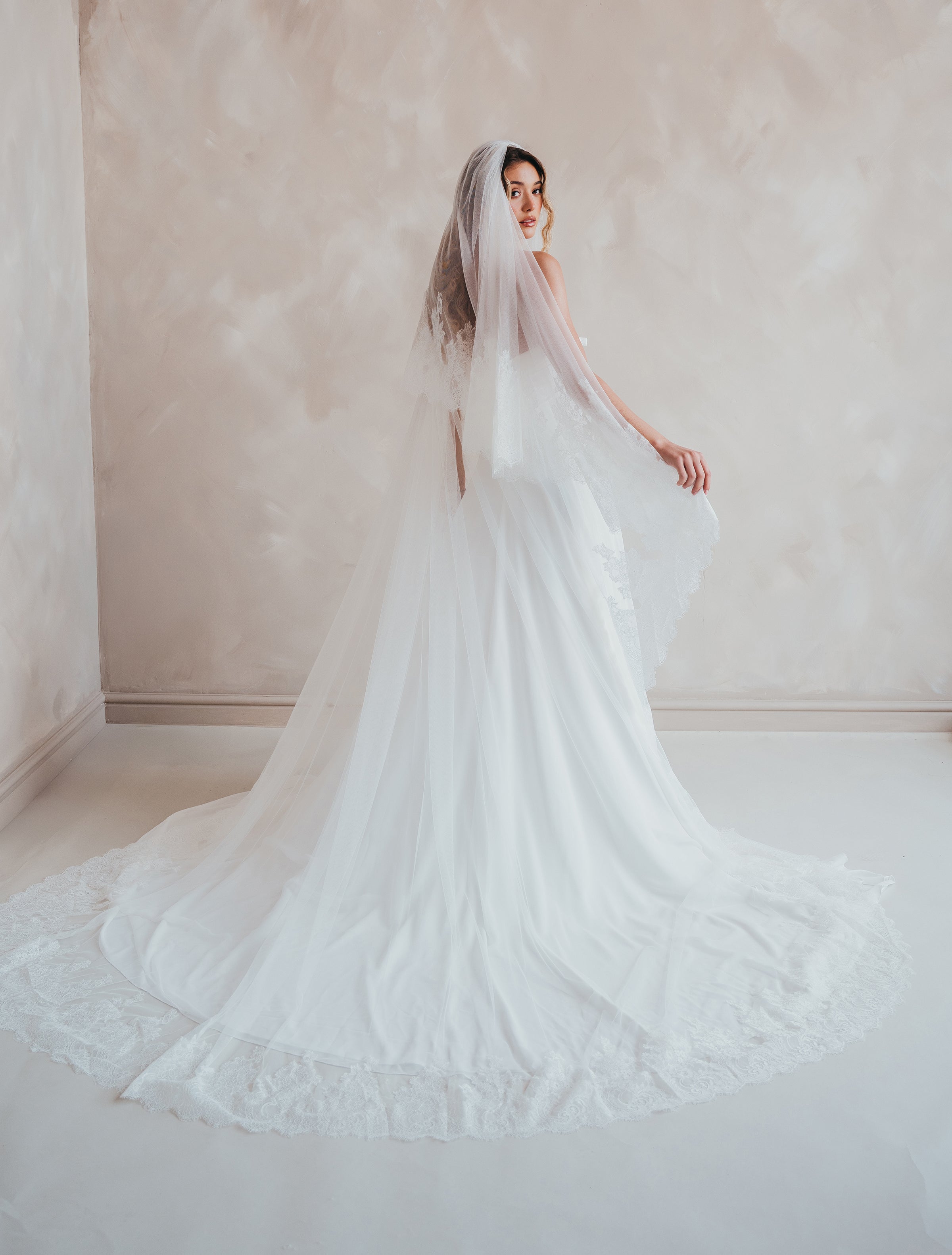 Bride wearing the Penelope two-tier Chantilly lace veil with eyelash edging.