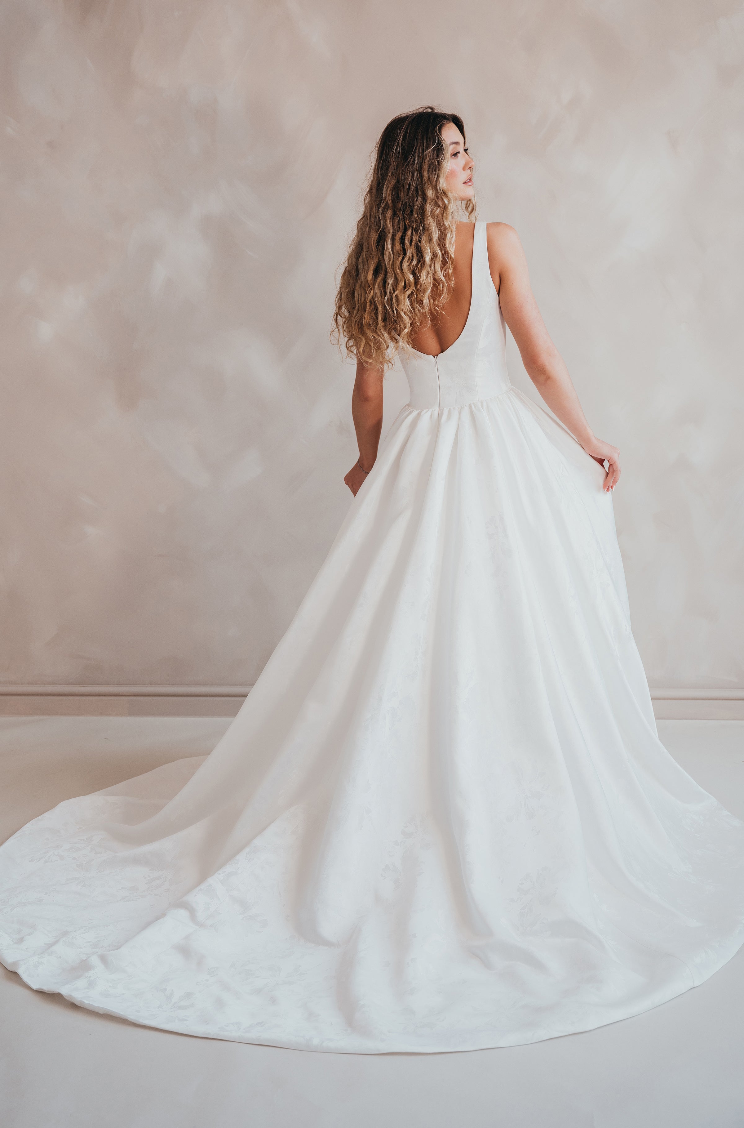 Bride wearing the Blossom floral satin A-line wedding dress with square neckline.