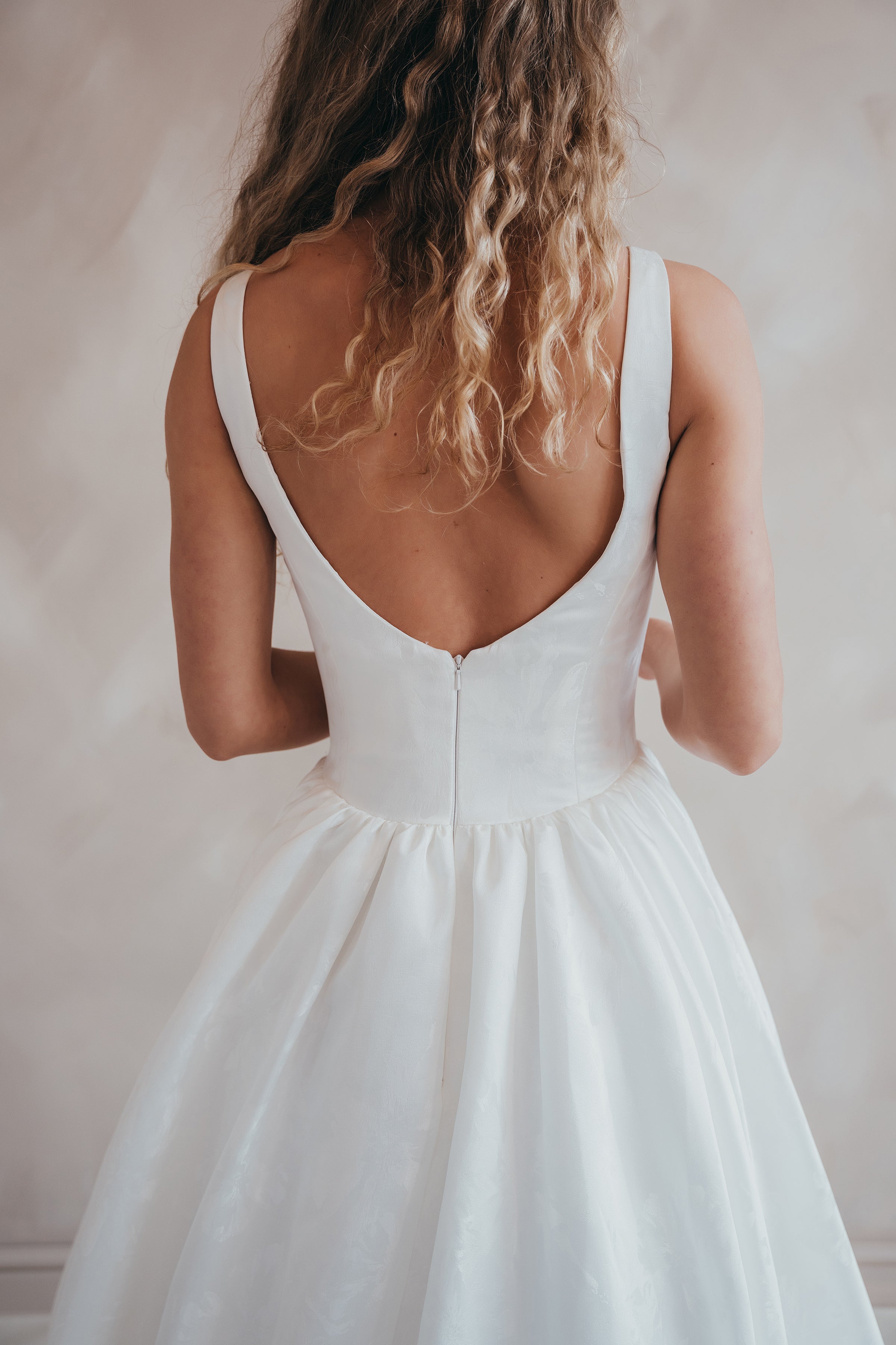 Bride wearing the Blossom floral satin A-line wedding dress with square neckline.
