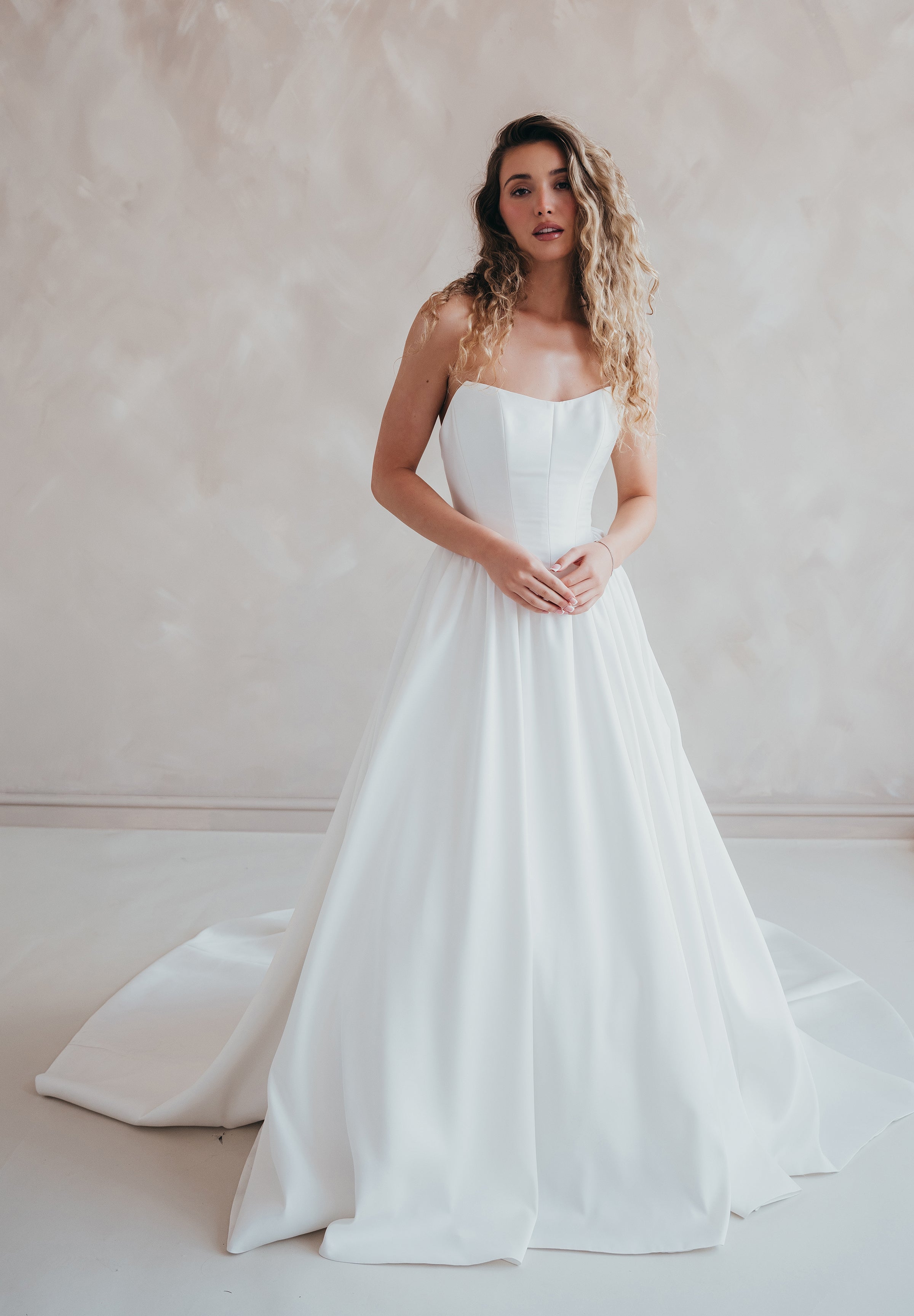 Bride wearing the Lua strapless Mikado wedding dress with pleated A-line skirt.