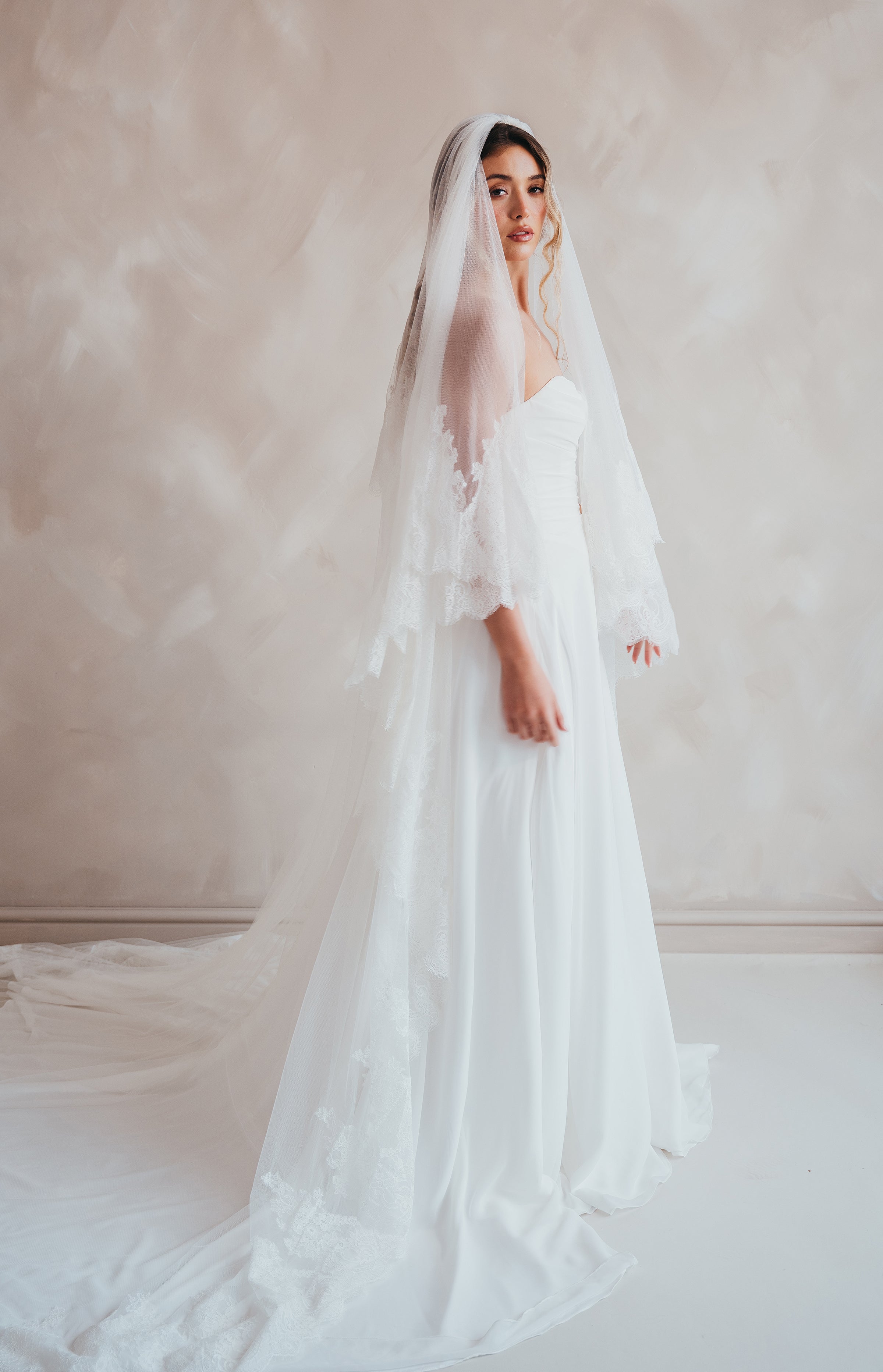 Bride wearing the Penelope two-tier Chantilly lace veil with eyelash edging.