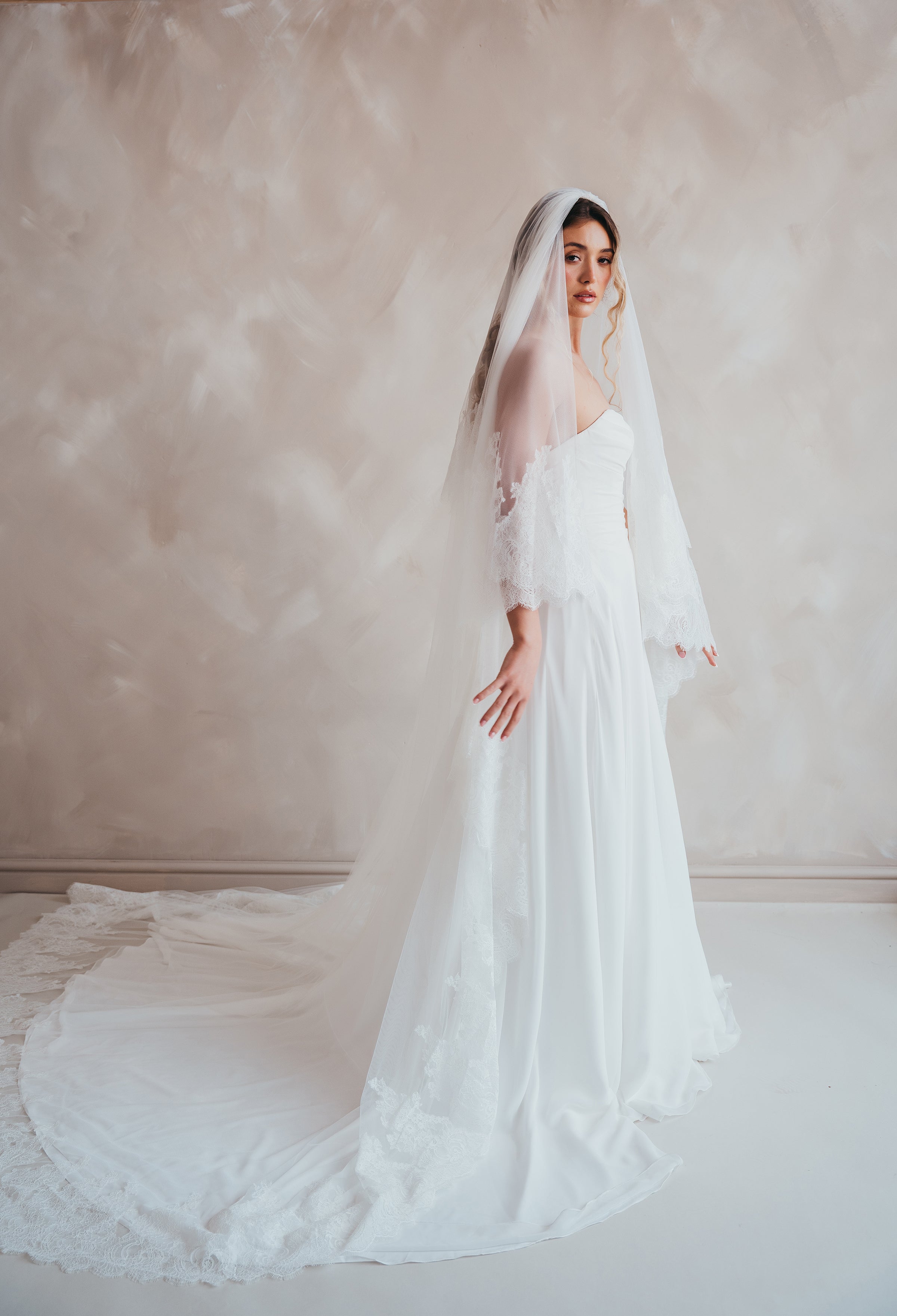 Bride wearing the Penelope two-tier Chantilly lace veil with eyelash edging.