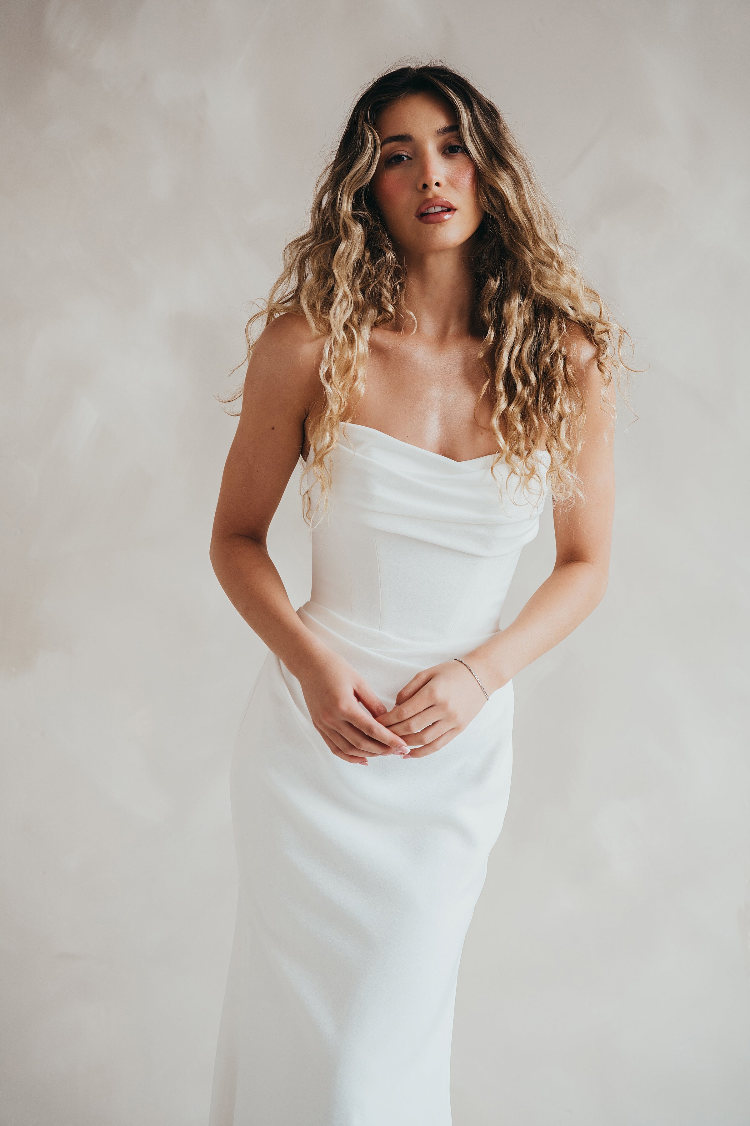 Bride wearing the Maple crepe wedding dress with ruched bust and corseted bodice.