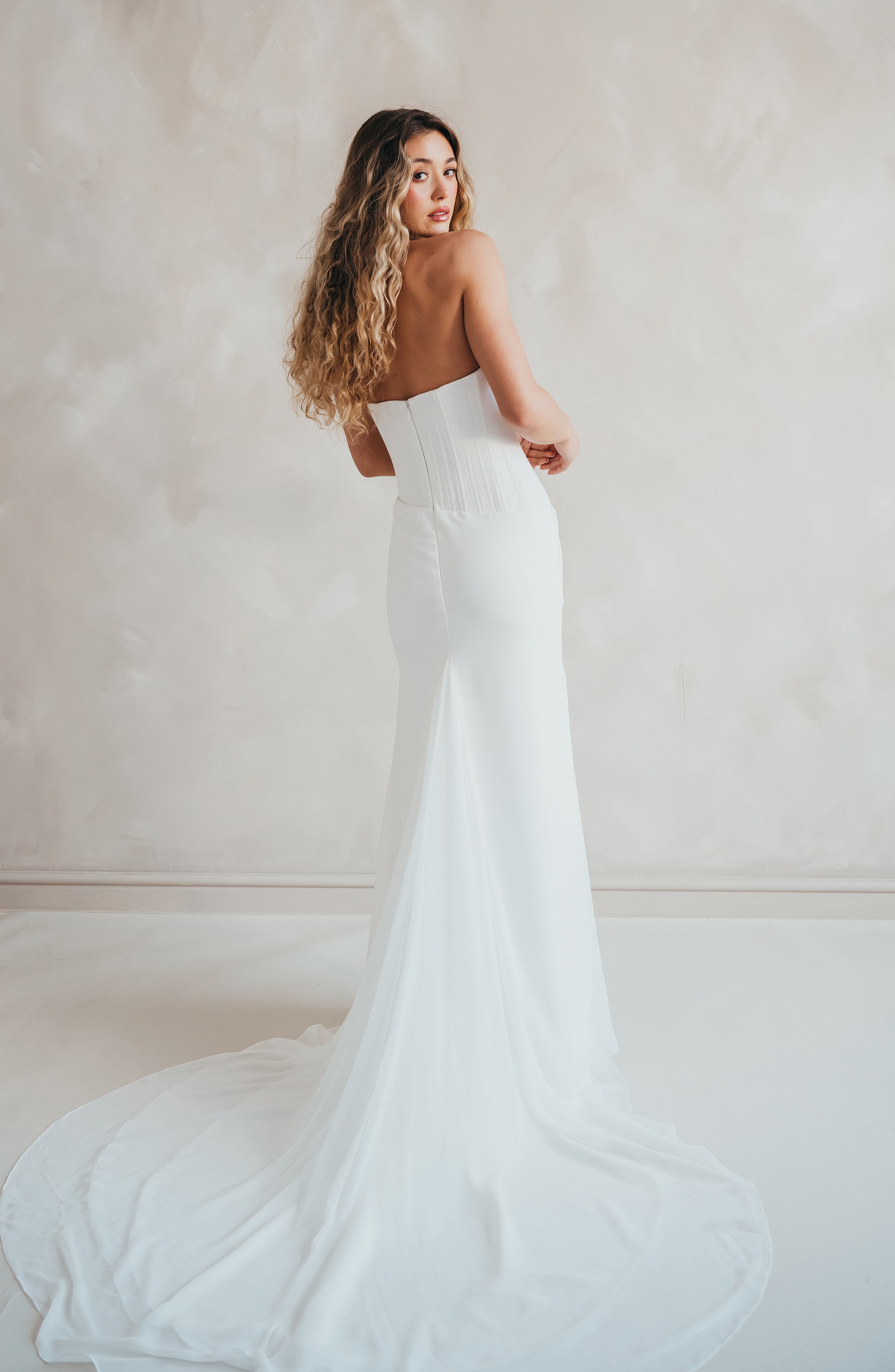 Bride wearing the Portia wedding dress with structured crepe bodice and flowing chiffon skirt.