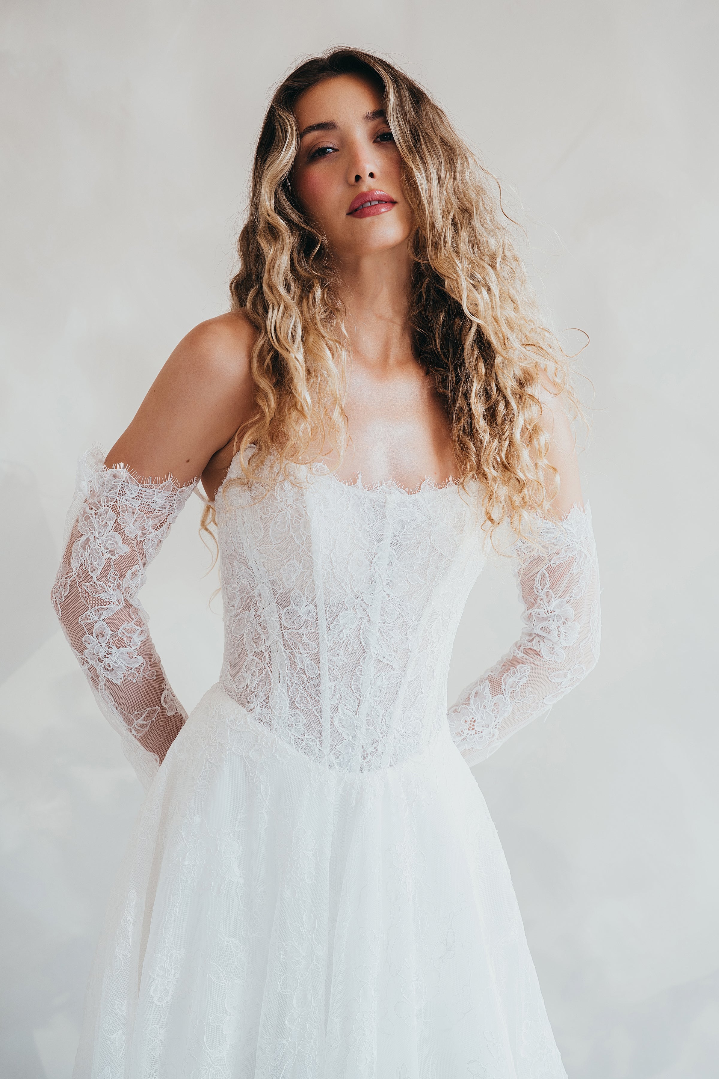 Bride wearing the Delilah lace wedding dress with dropped waist and layered A-line skirt.