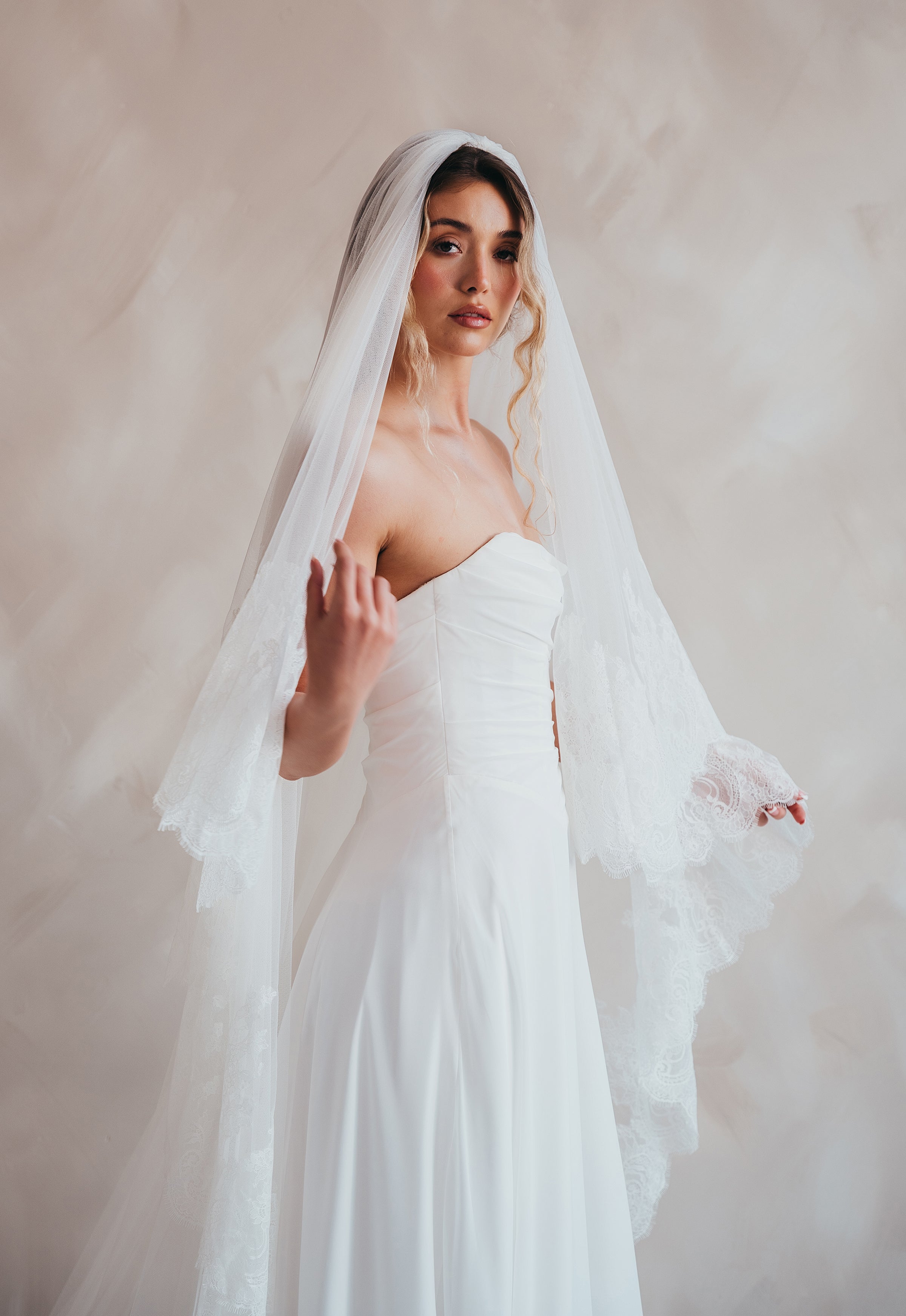 Bride wearing the Penelope two-tier Chantilly lace veil with eyelash edging.