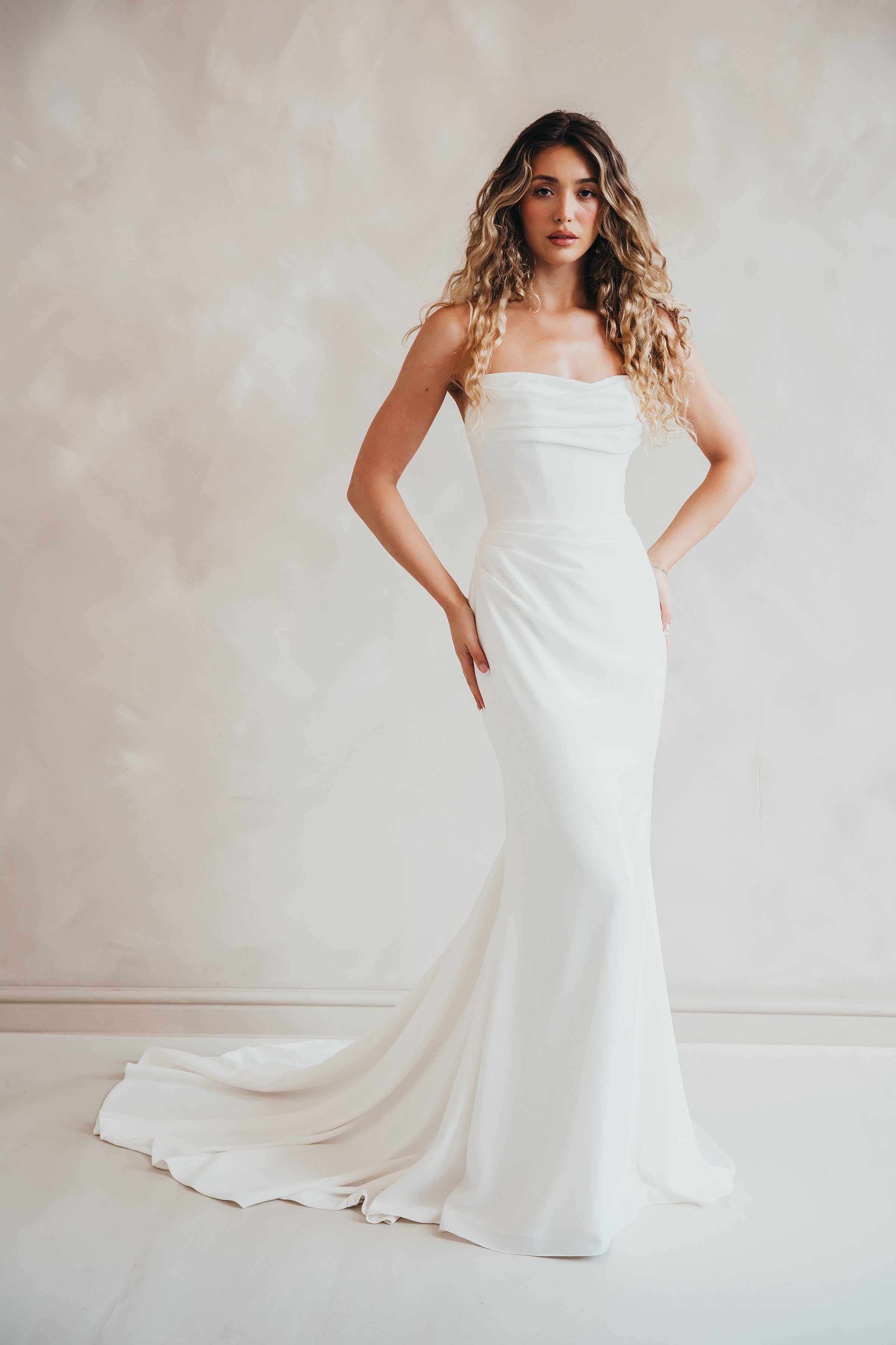 Bride wearing the Maple crepe wedding dress with ruched bust and corseted bodice.