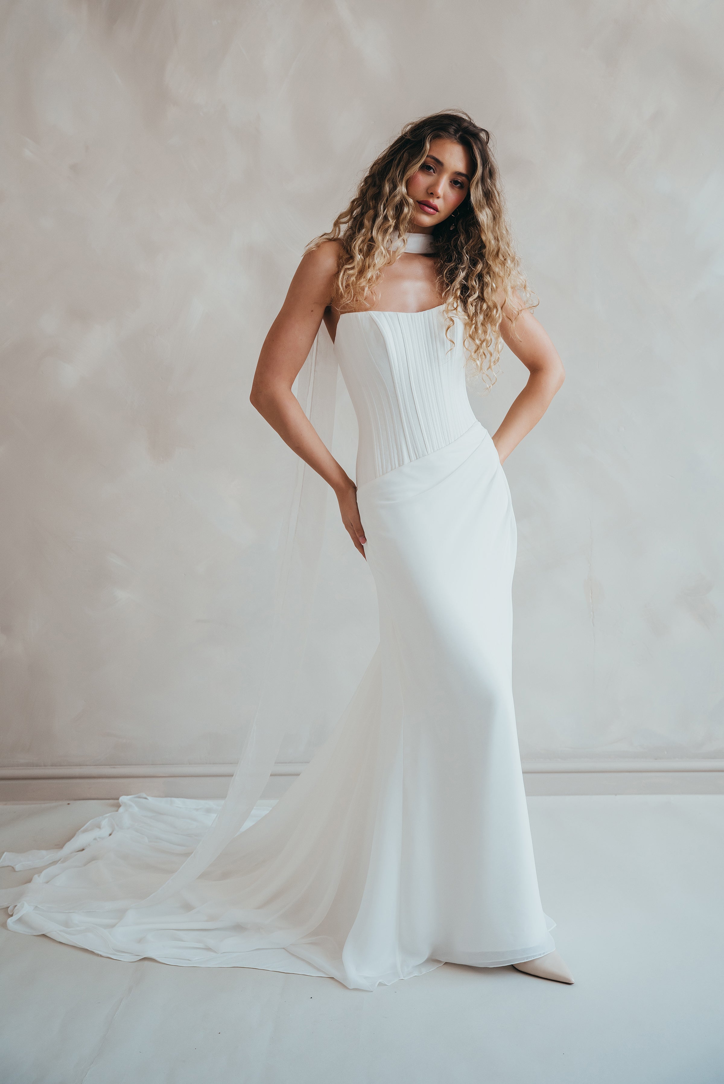 Bride wearing the Portia wedding dress with structured crepe bodice and flowing chiffon skirt.