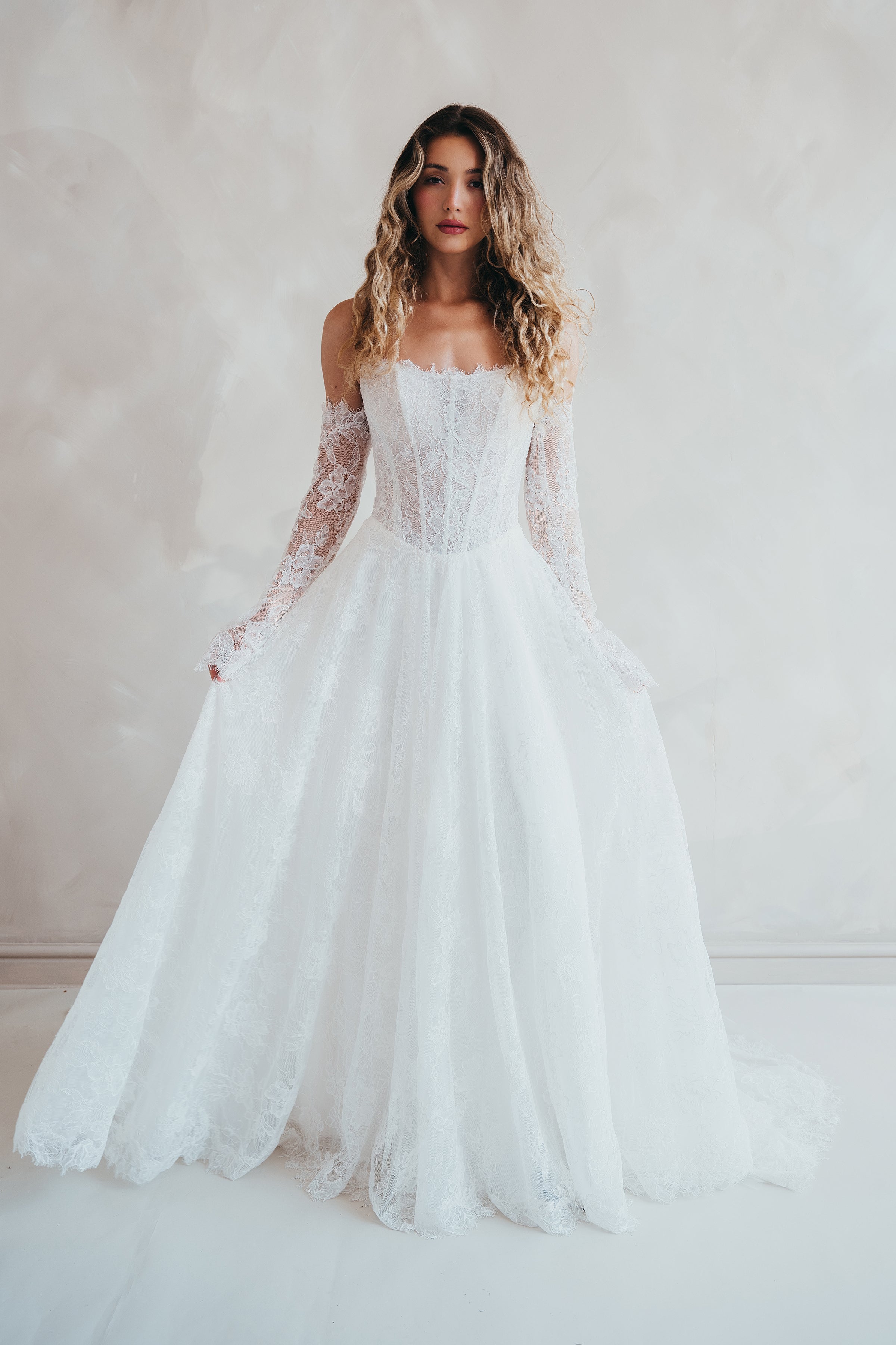 Bride wearing the Delilah lace wedding dress with dropped waist and layered A-line skirt.