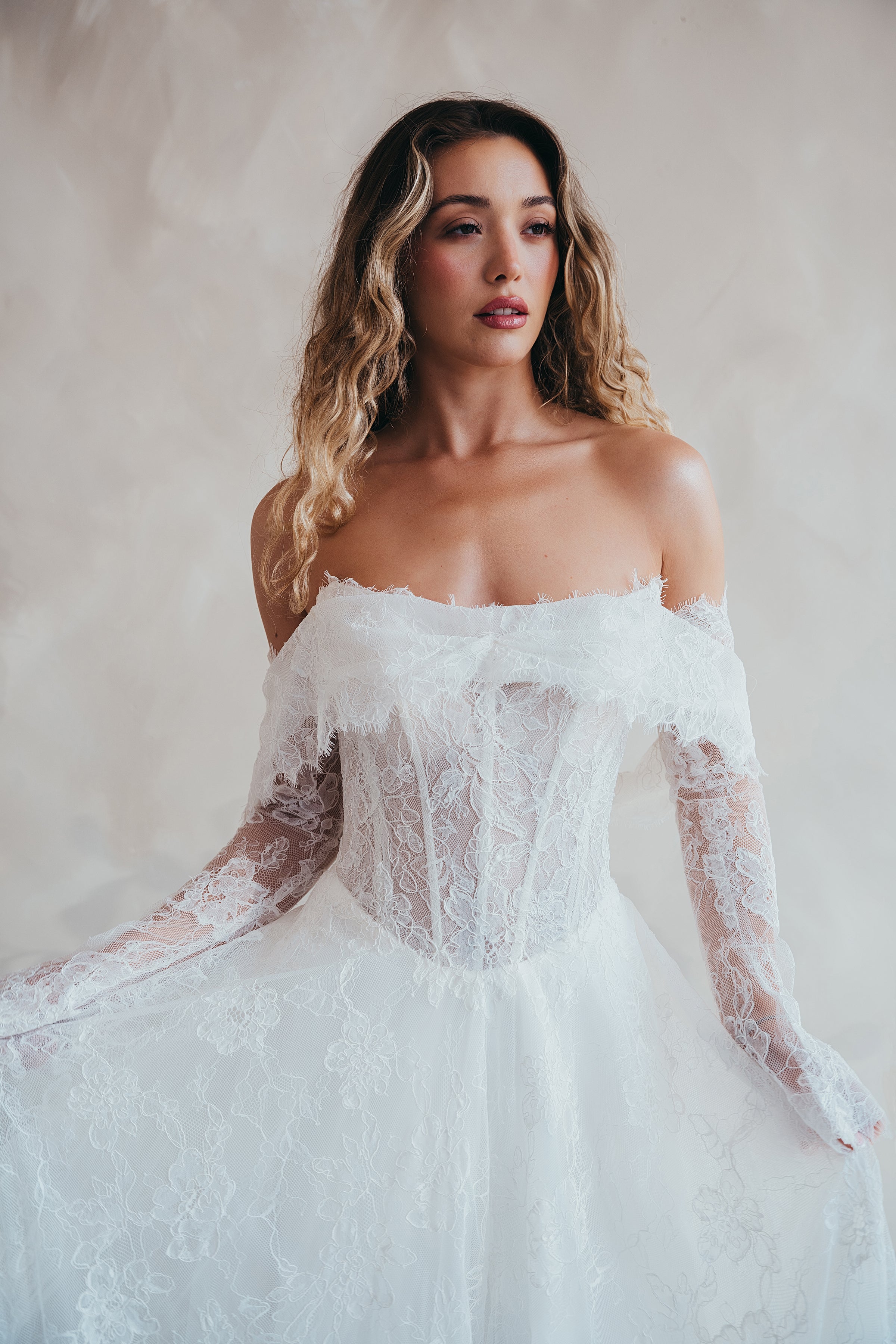 Bride wearing the Delilah lace wedding dress with dropped waist and layered A-line skirt.