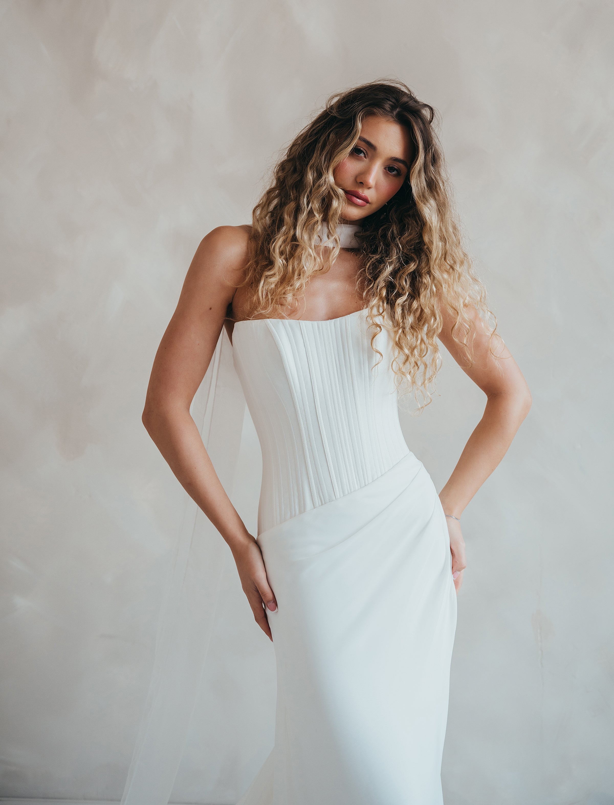 Bride wearing the Portia wedding dress with structured crepe bodice and flowing chiffon skirt.