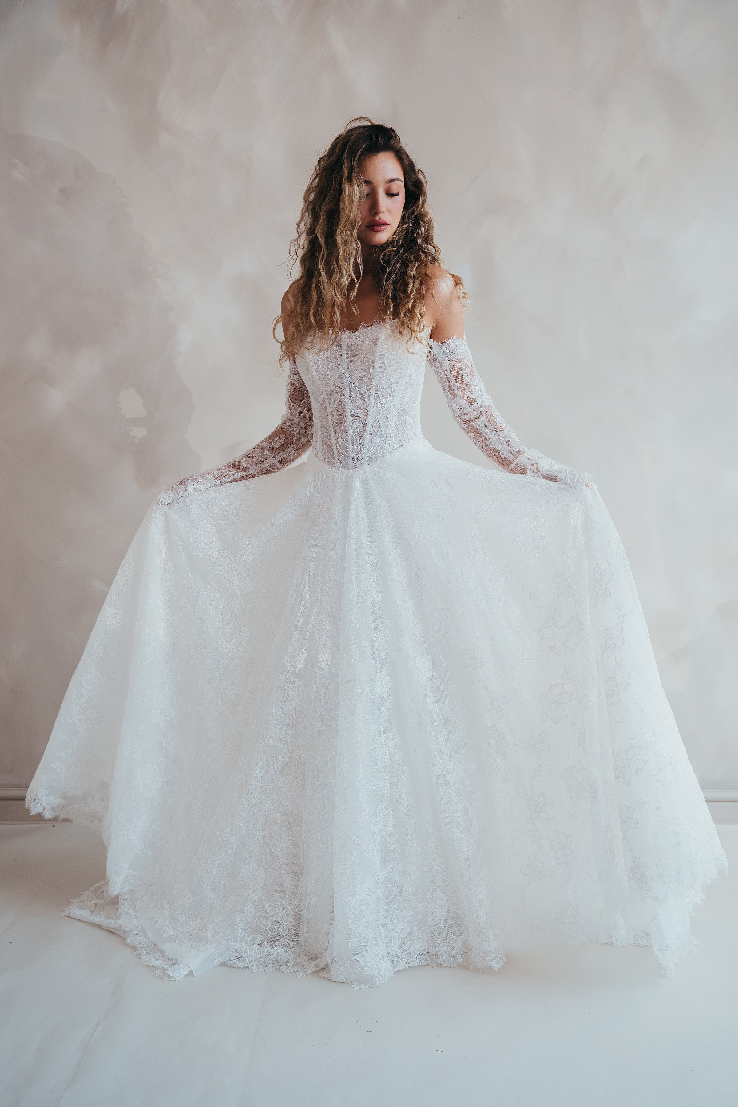 Bride wearing the Delilah lace wedding dress with dropped waist and layered A-line skirt.