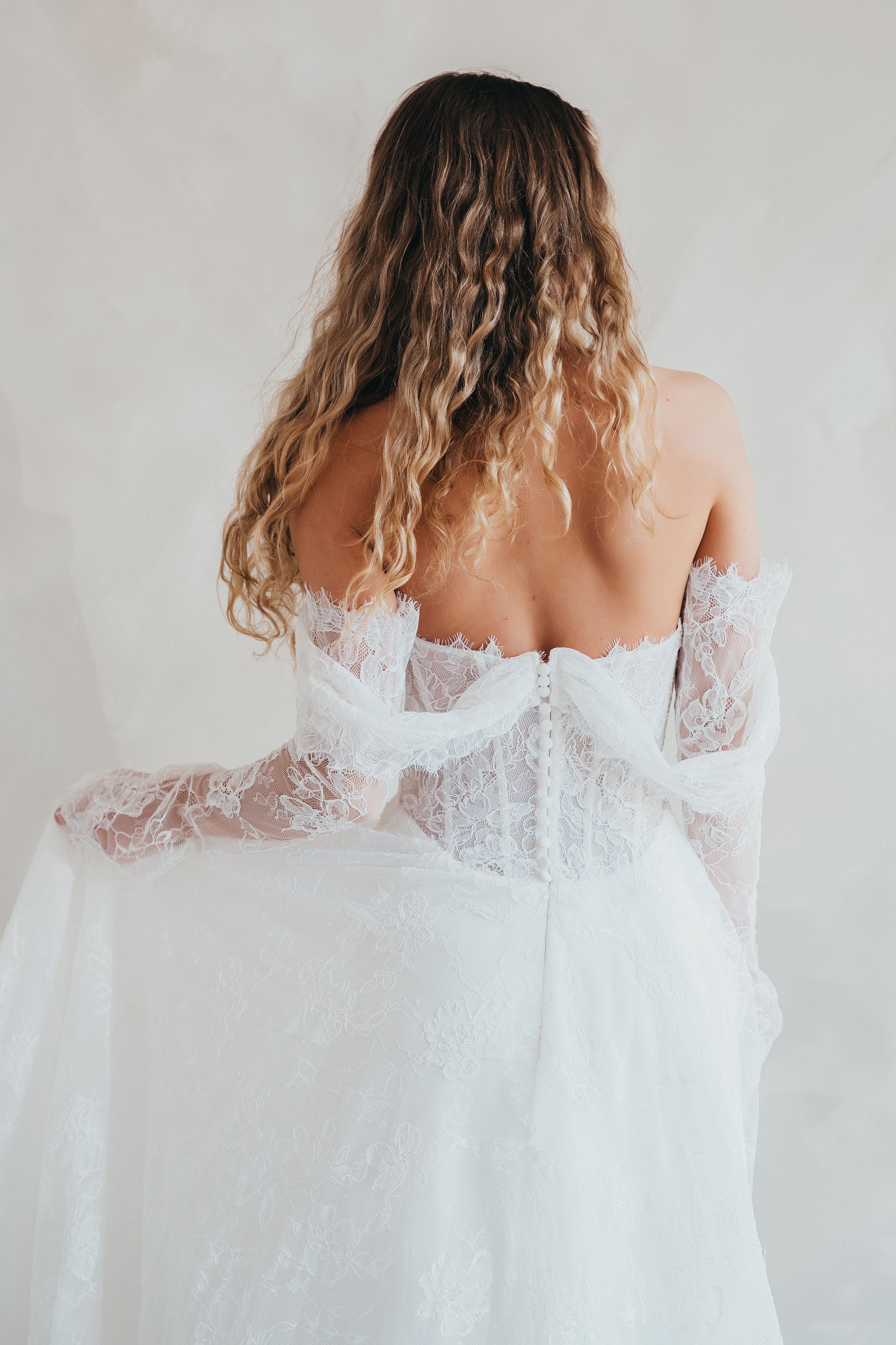 Bride wearing the Delilah lace wedding dress with dropped waist and layered A-line skirt.