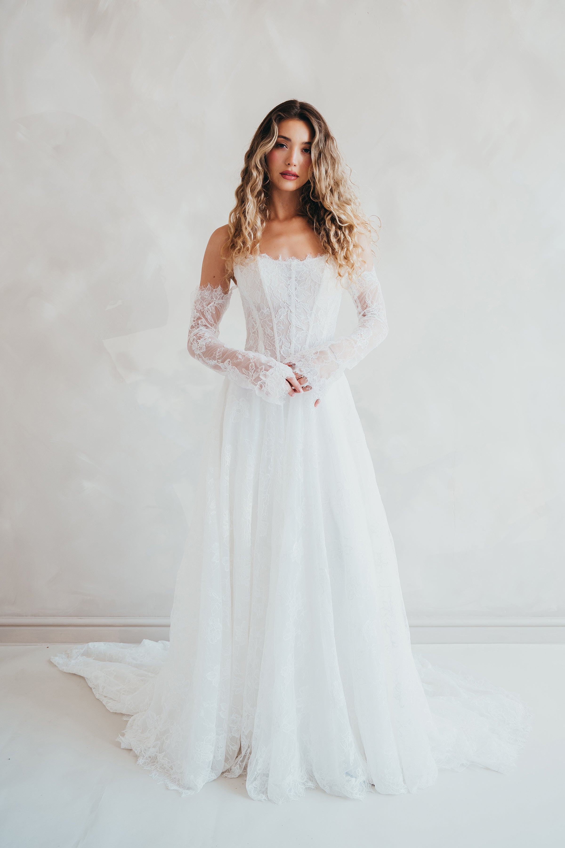 Bride wearing the Delilah lace wedding dress with dropped waist and layered A-line skirt.