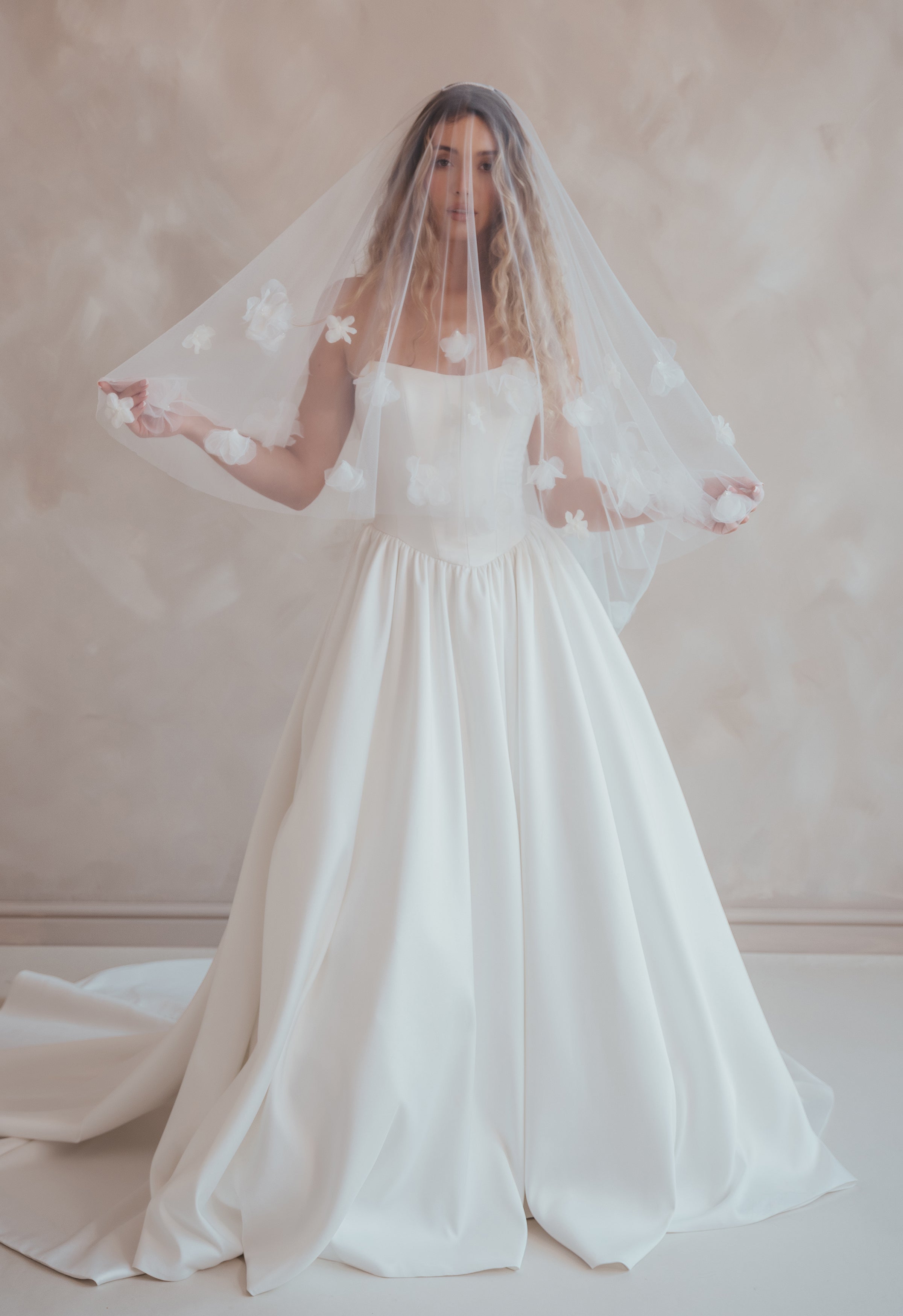 Bride wearing the Luz Shortie veil with floral detailing and blusher.