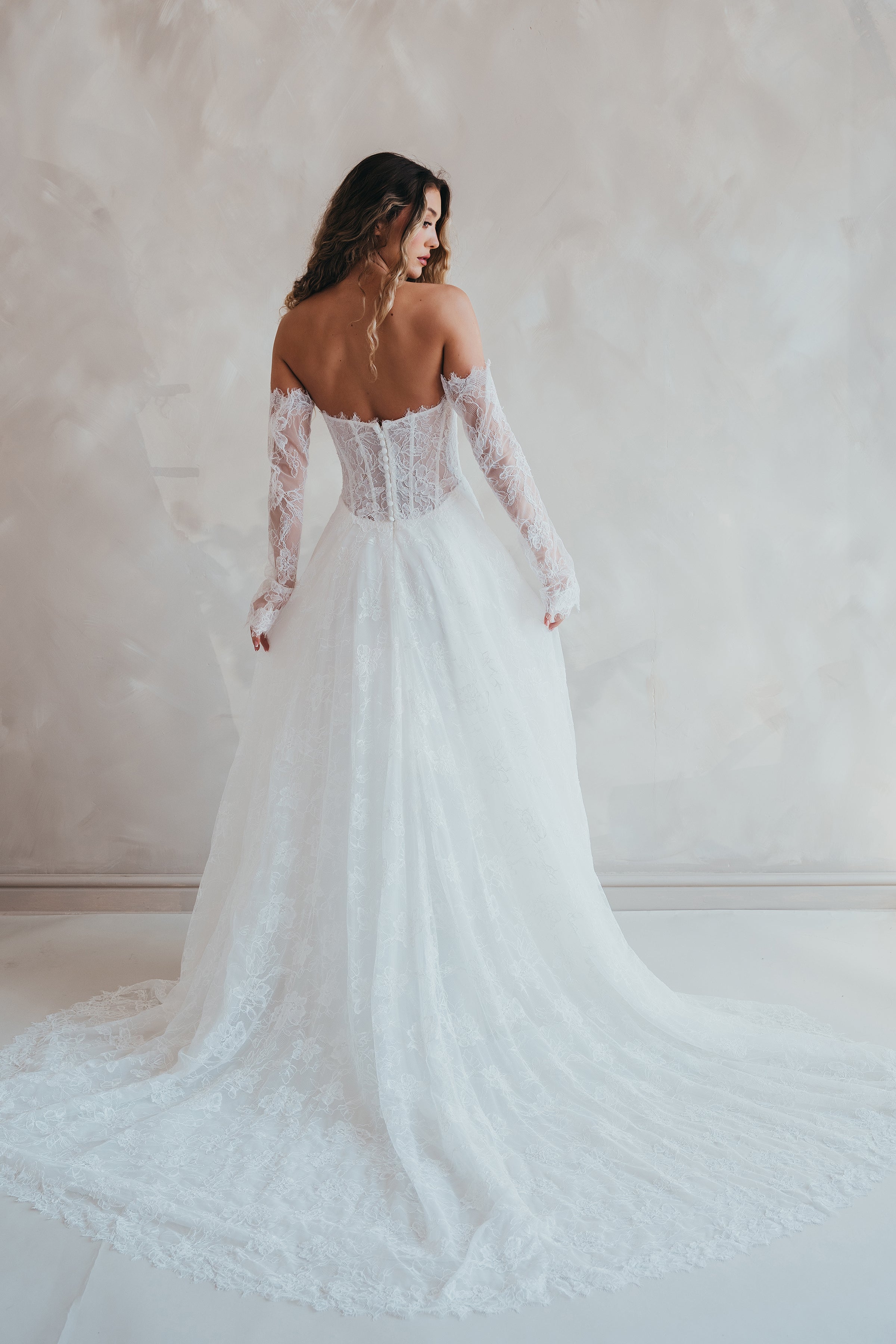 Bride wearing the Delilah lace wedding dress with dropped waist and layered A-line skirt.