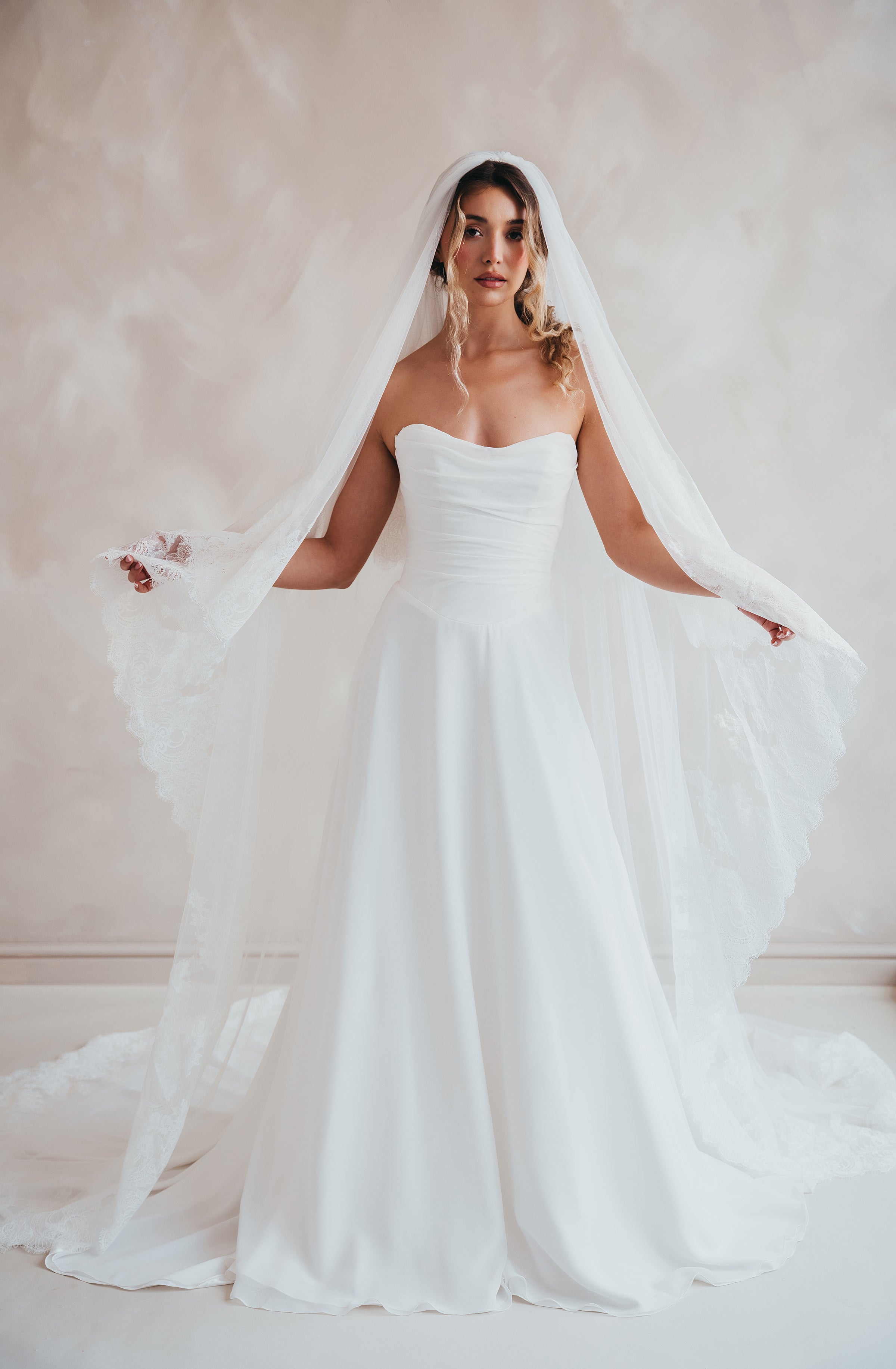 Bride wearing the Penelope two-tier Chantilly lace veil with eyelash edging.