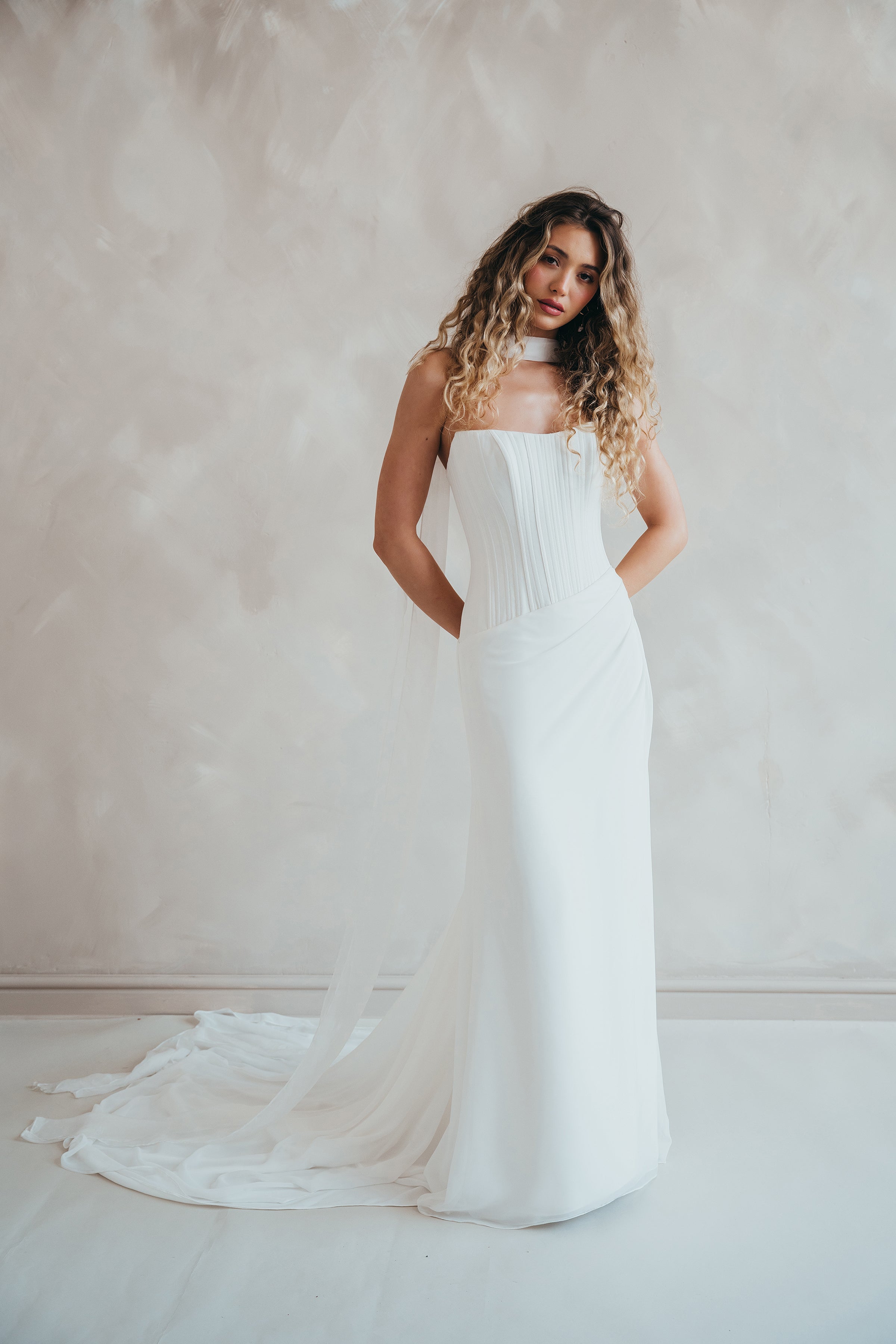 Bride wearing the Portia wedding dress with structured crepe bodice and flowing chiffon skirt.
