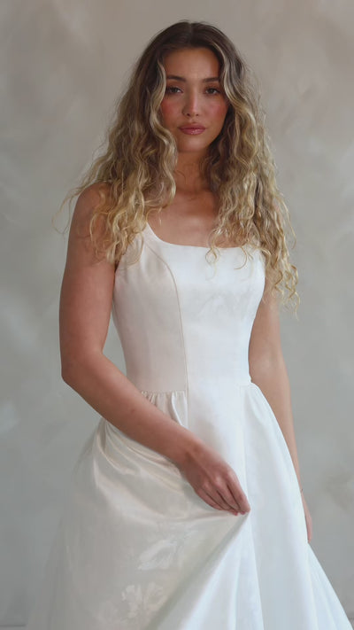Bride wearing the Blossom floral satin A-line wedding dress with square neckline.