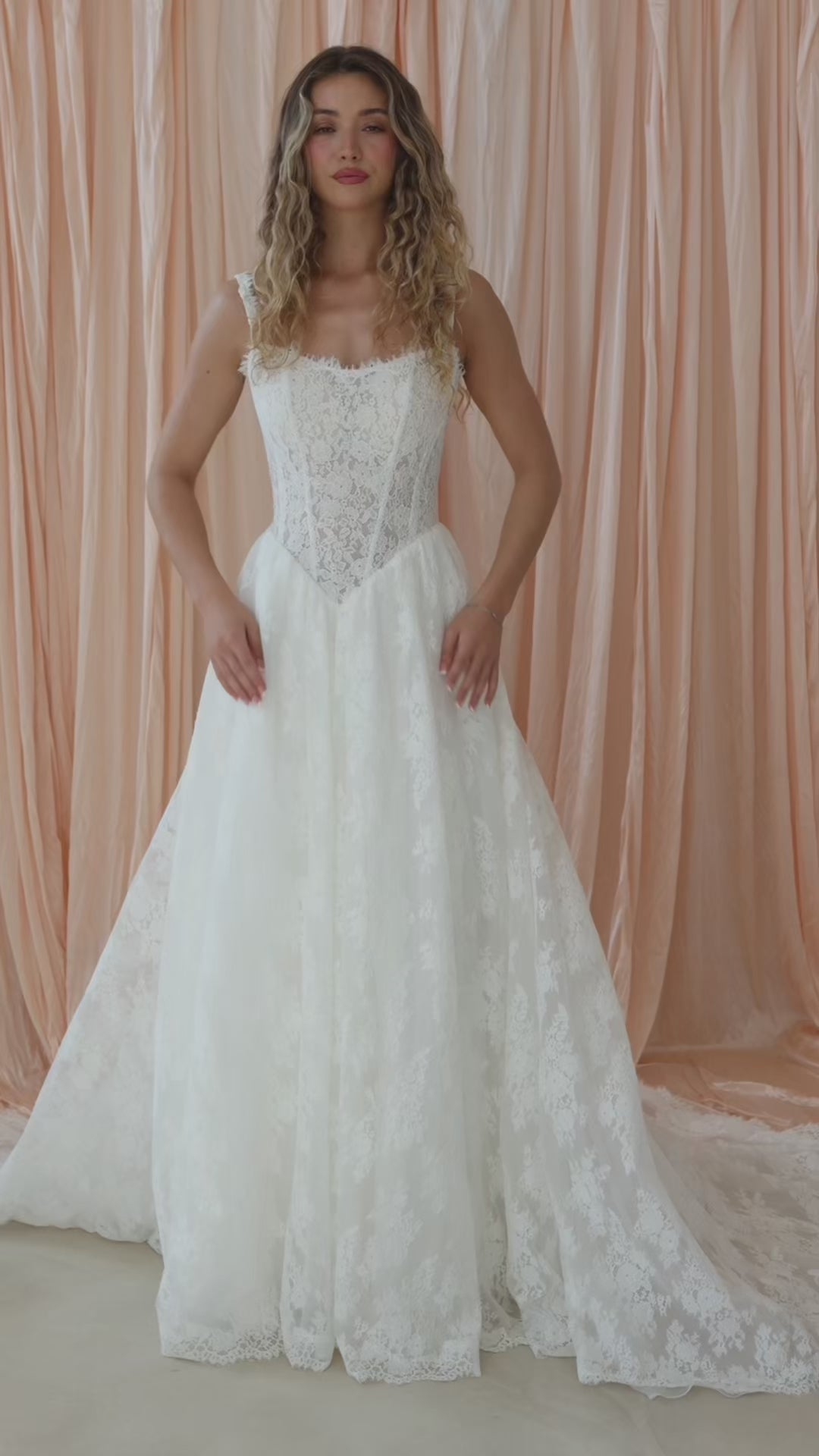 Bride wearing the Noemie Chantilly lace A-line wedding dress with square neckline and Basque waist.