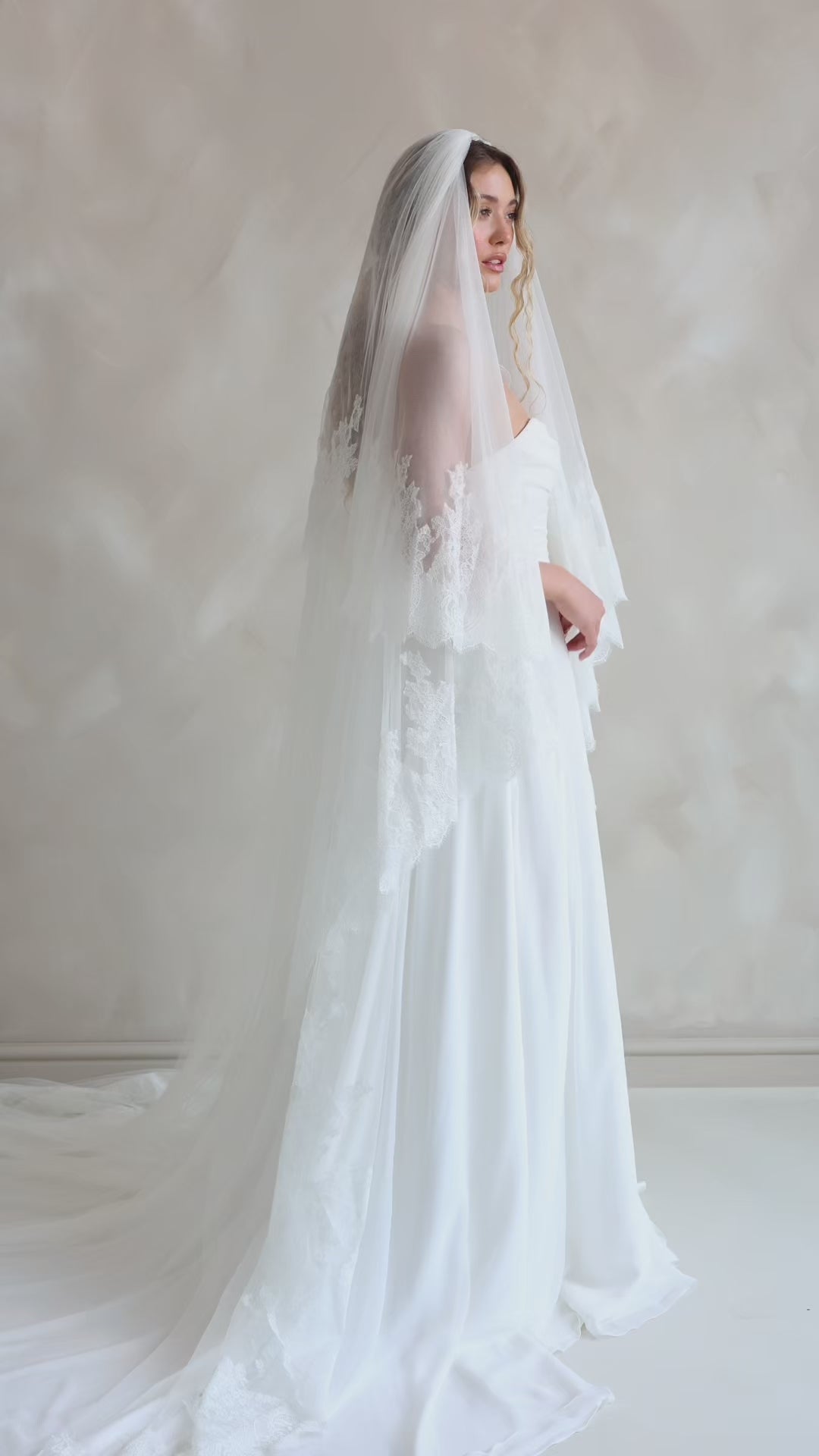 Bride wearing the Penelope two-tier Chantilly lace veil with eyelash edging.