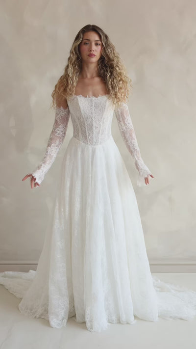 Bride wearing the Delilah lace wedding dress with dropped waist and layered A-line skirt.