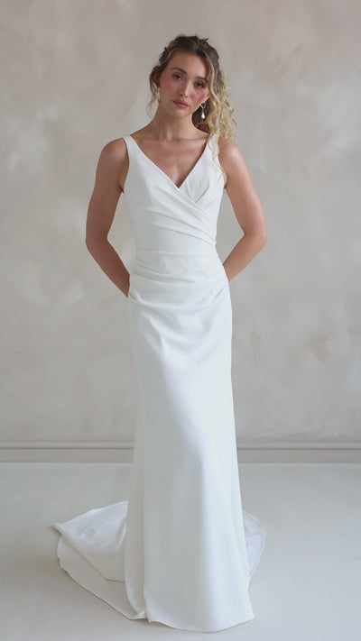 Bride wearing the Clover V-neck stretch crepe wedding dress with pleated bodice.