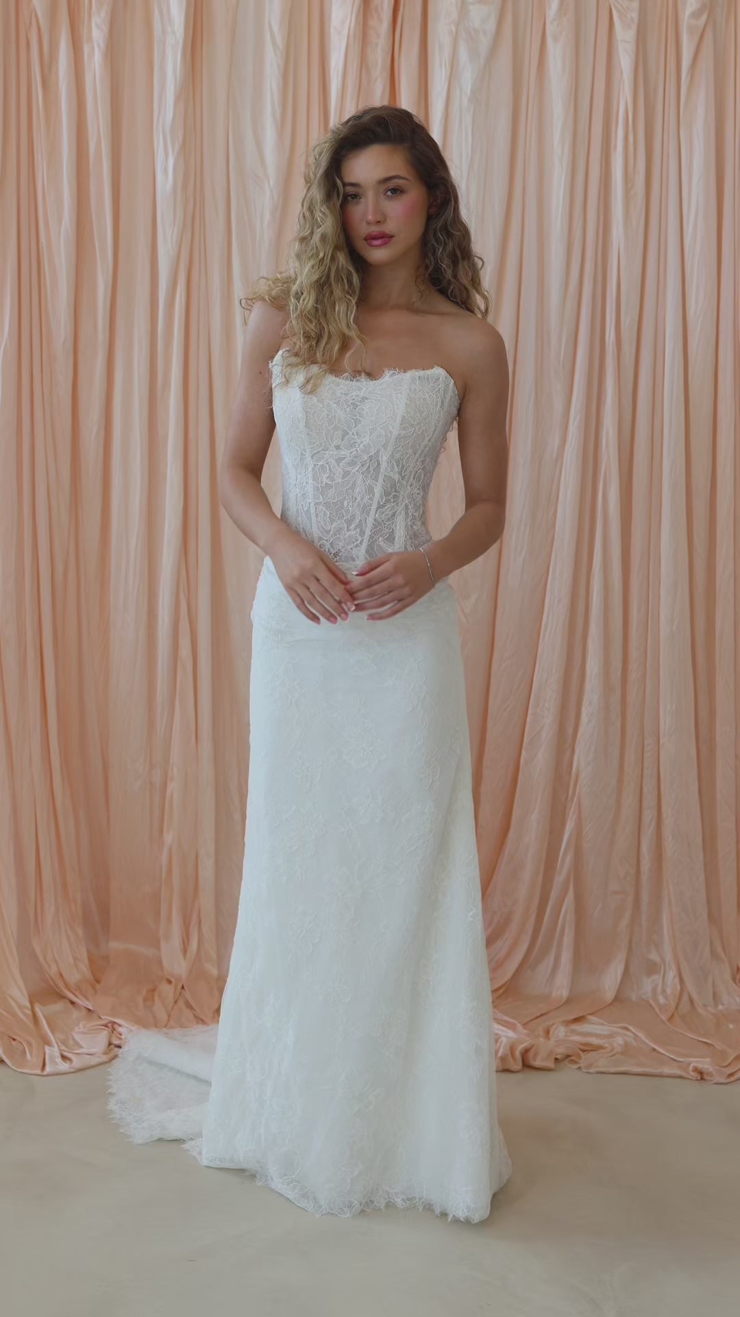 Bride wearing the Dalia strapless fitted lace wedding dress with dropped waist silhouette.