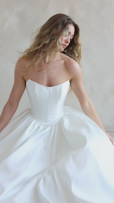 Bride wearing the Lua strapless Mikado wedding dress with pleated A-line skirt.