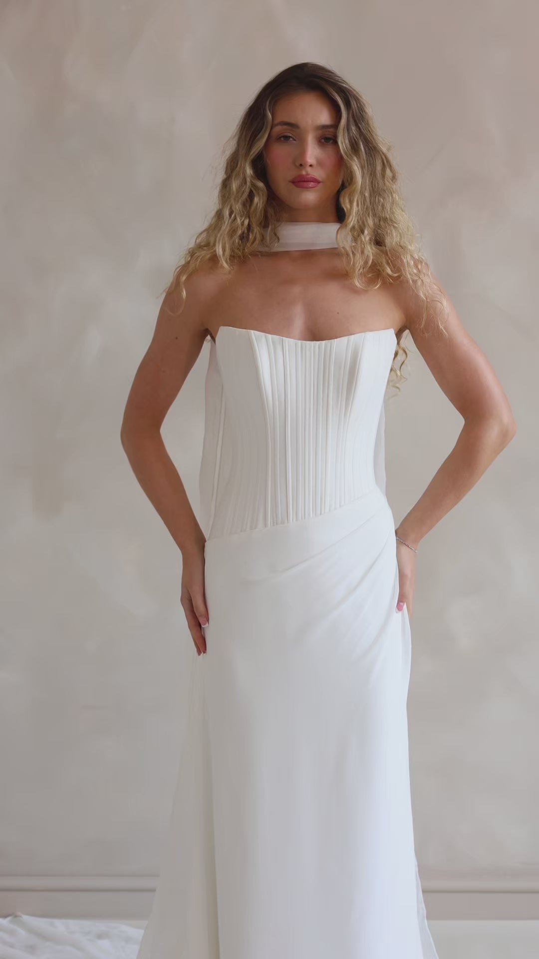 Bride wearing the Portia wedding dress with structured crepe bodice and flowing chiffon skirt.