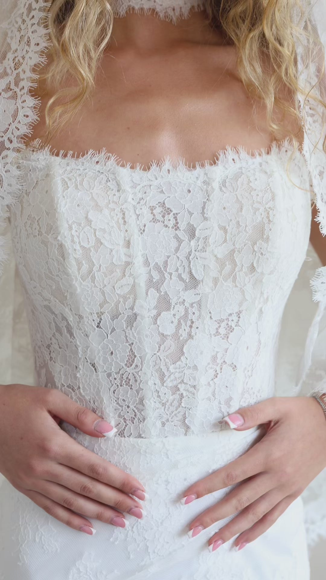 Bride wearing the Laurelle strapless Chantilly lace wedding dress with fit-and-flare silhouette.