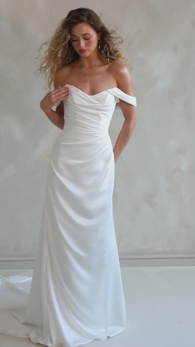 Bride wearing the Pearl satin wedding dress with sweetheart neckline and bardot sleeves.