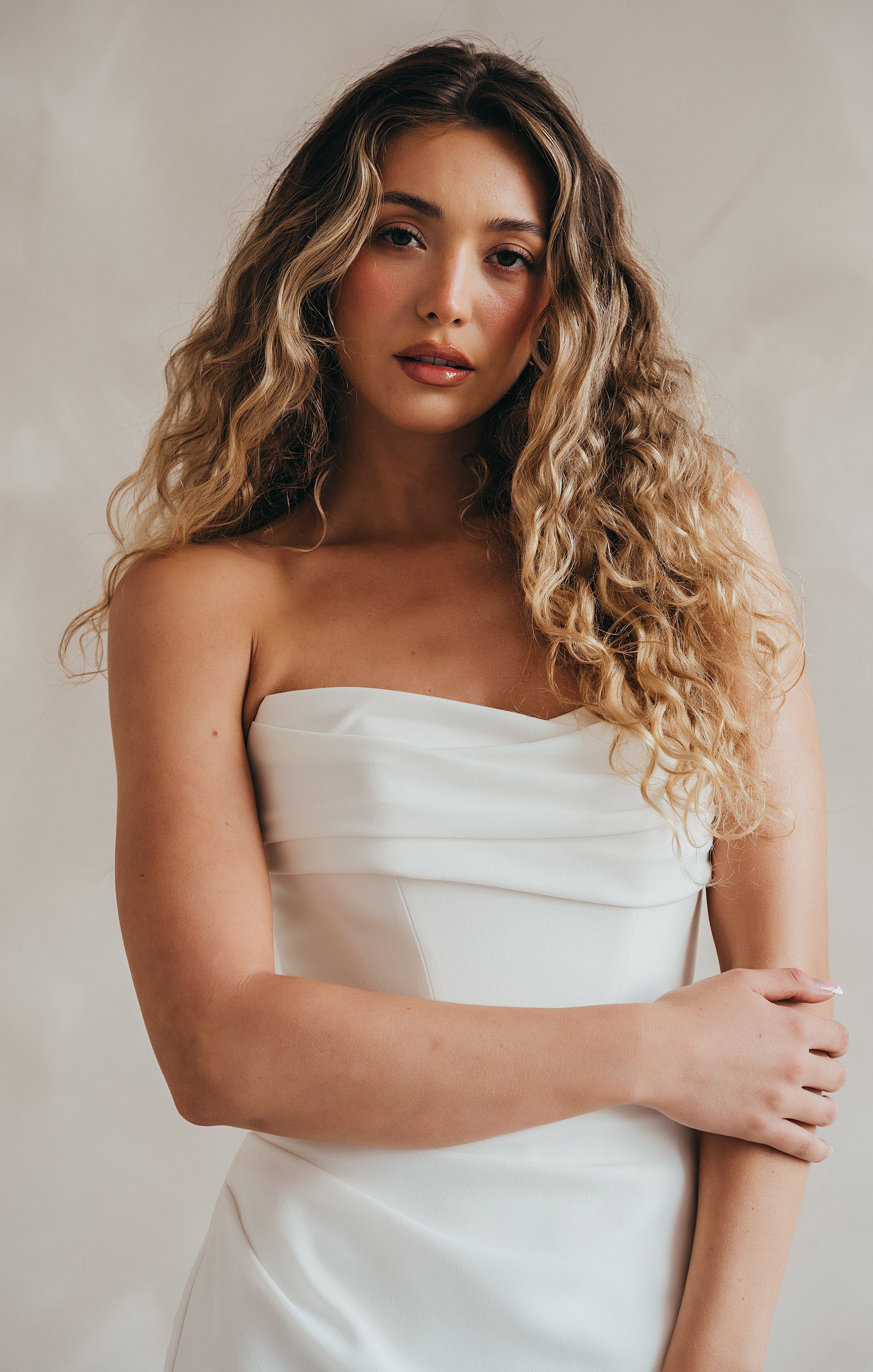 Bride wearing the Maple crepe wedding dress with ruched bust and corseted bodice.