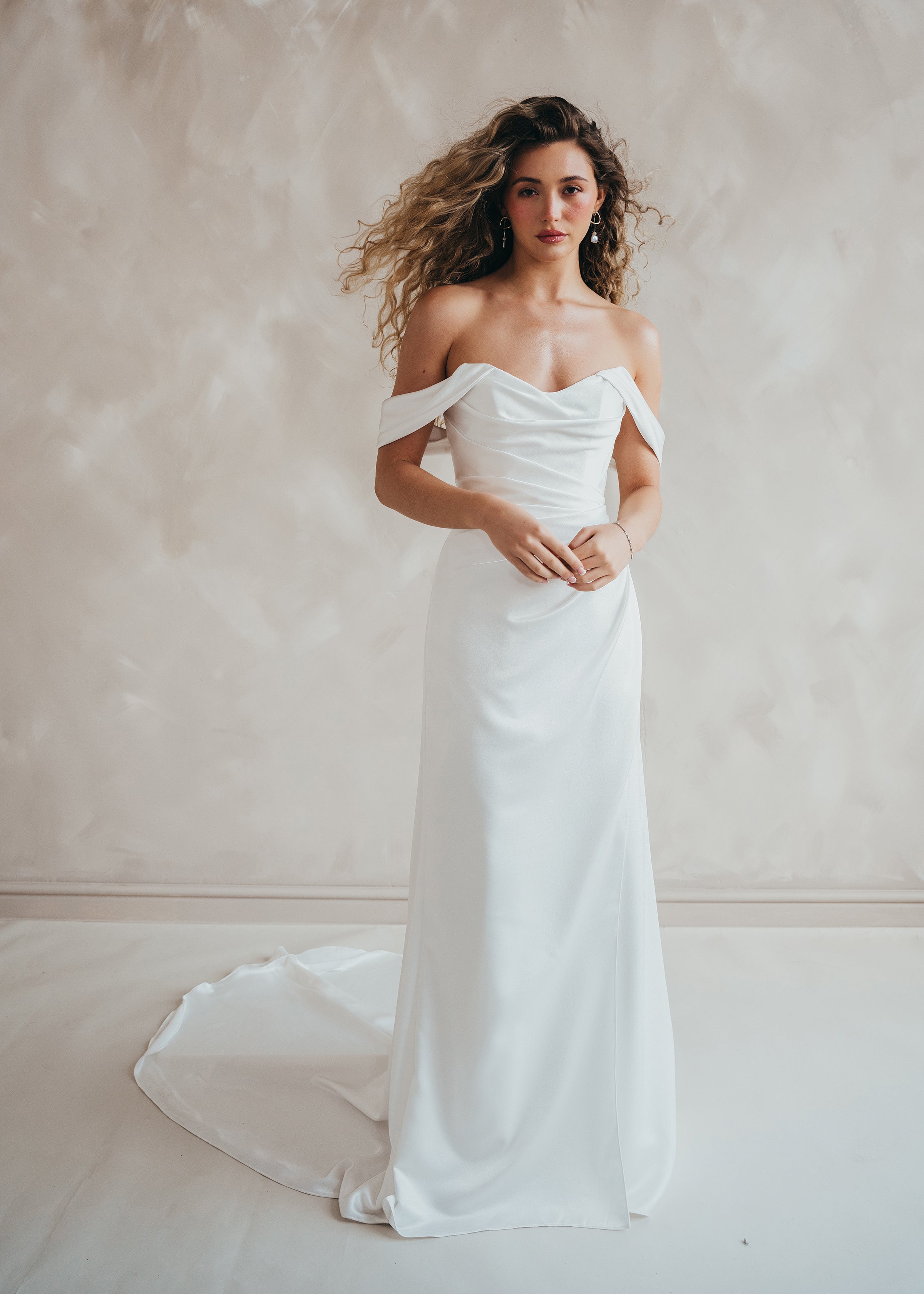 Bride wearing the Pearl satin wedding dress with sweetheart neckline and bardot sleeves.