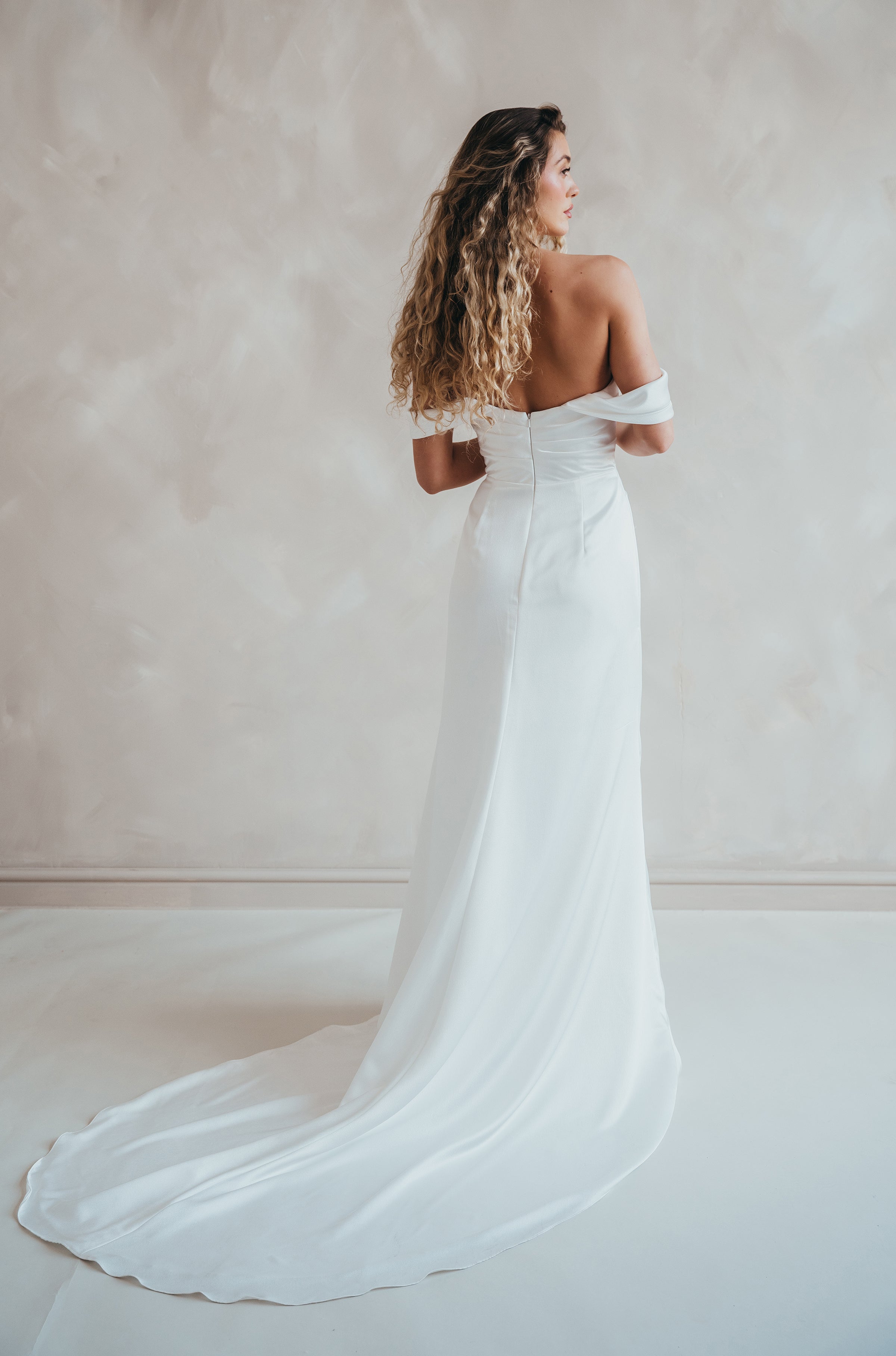 Bride wearing the Pearl satin wedding dress with sweetheart neckline and bardot sleeves.