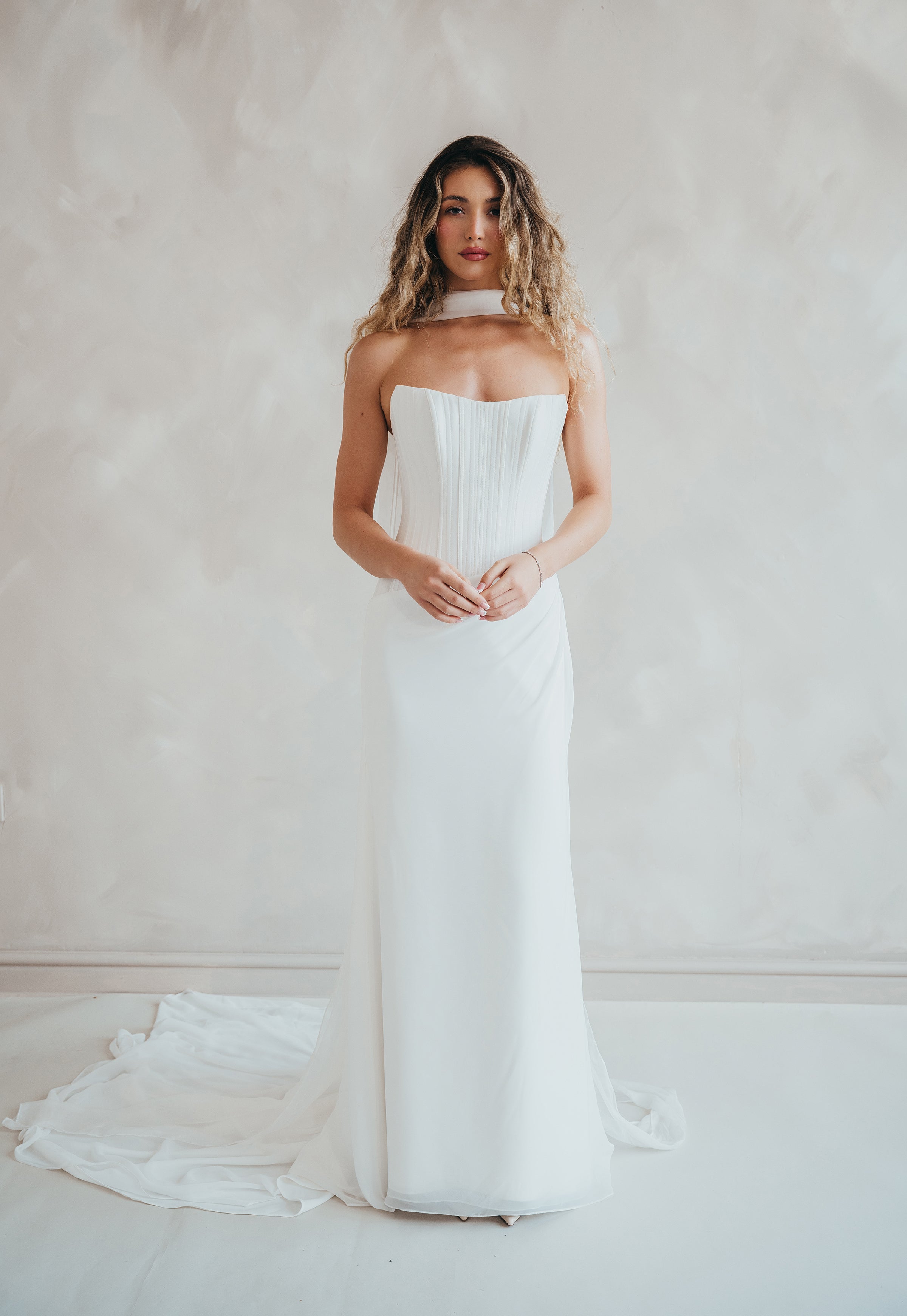 Bride wearing the Portia wedding dress with structured crepe bodice and flowing chiffon skirt.