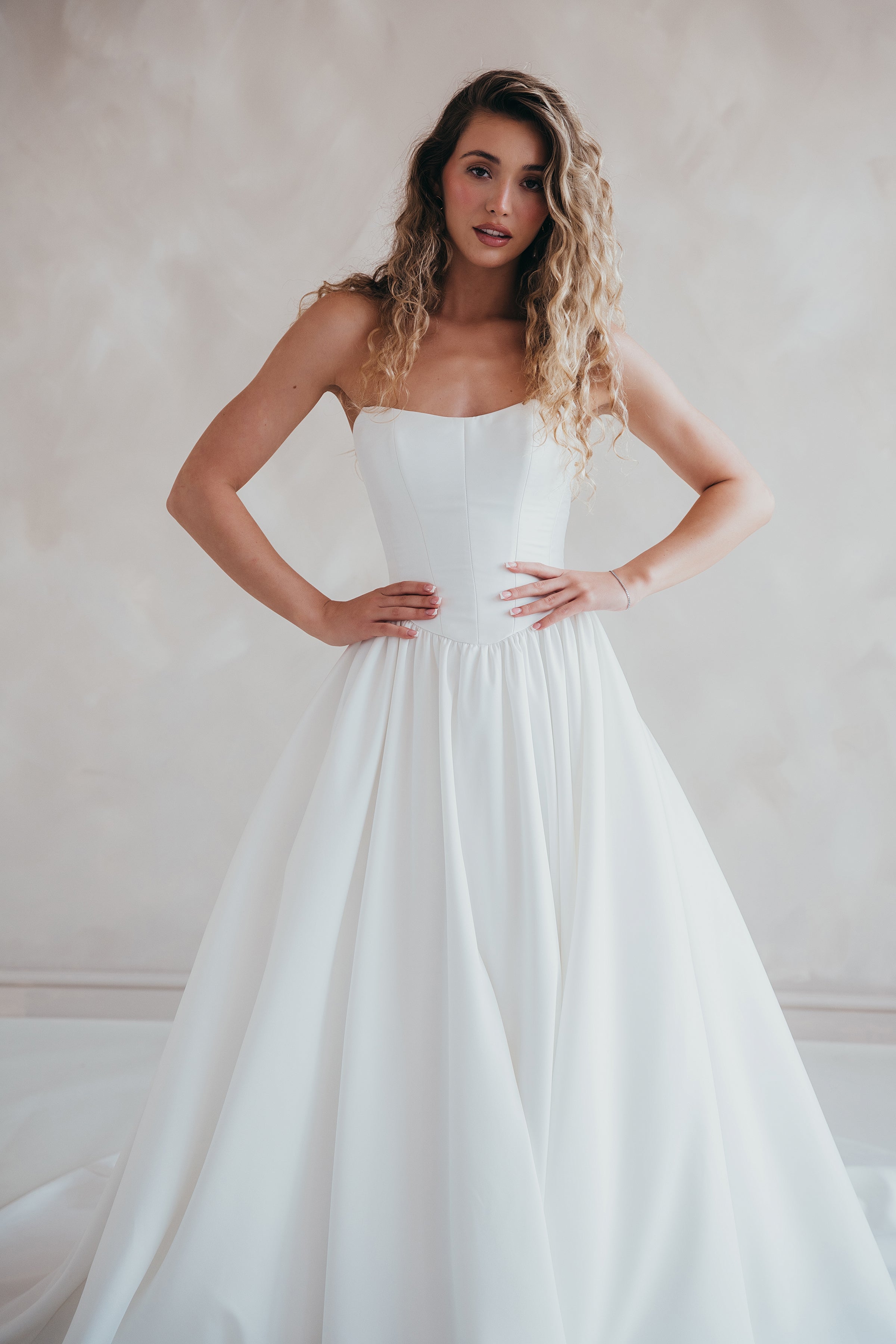 Bride wearing the Lua strapless Mikado wedding dress with pleated A-line skirt.