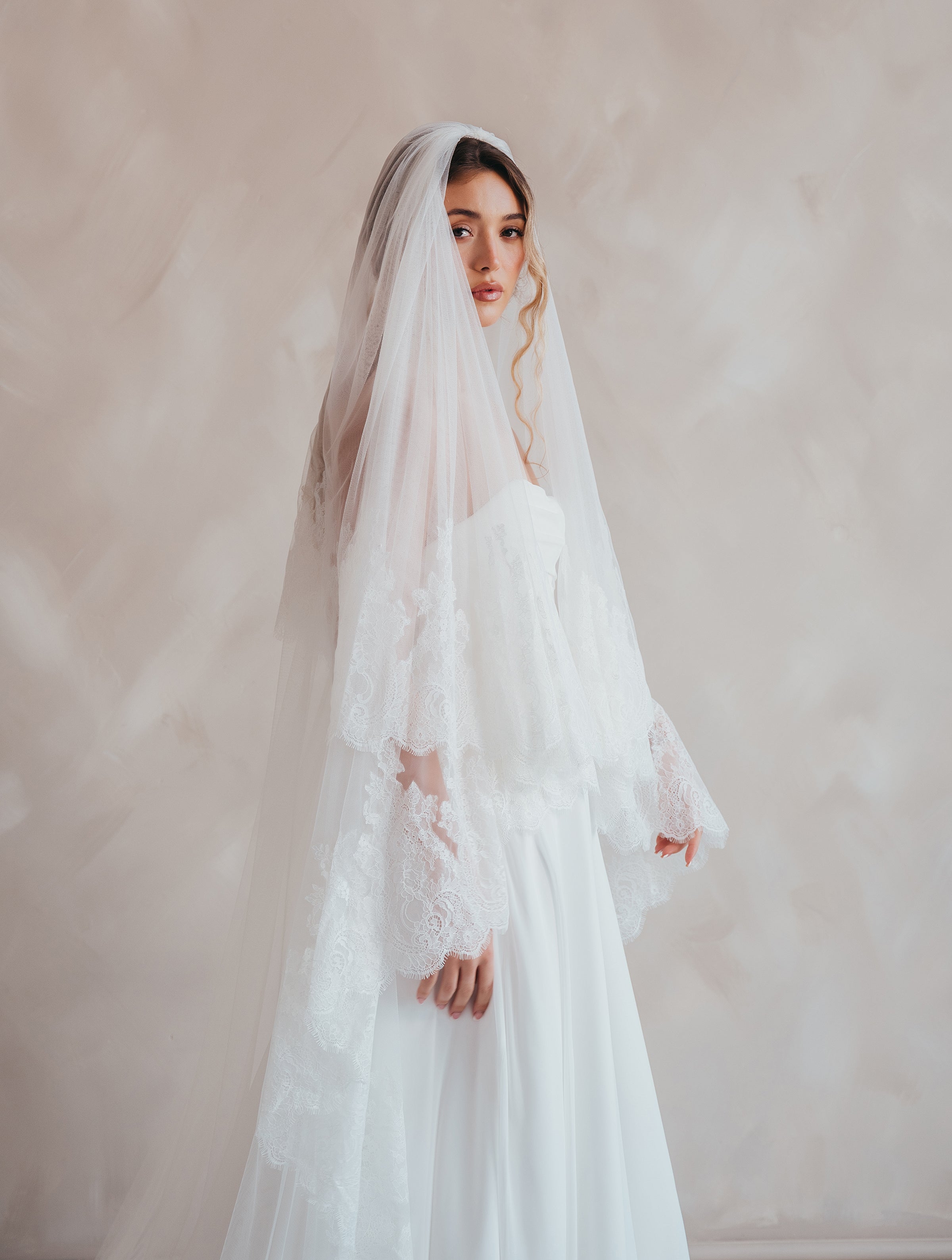 Bride wearing the Penelope two-tier Chantilly lace veil with eyelash edging.