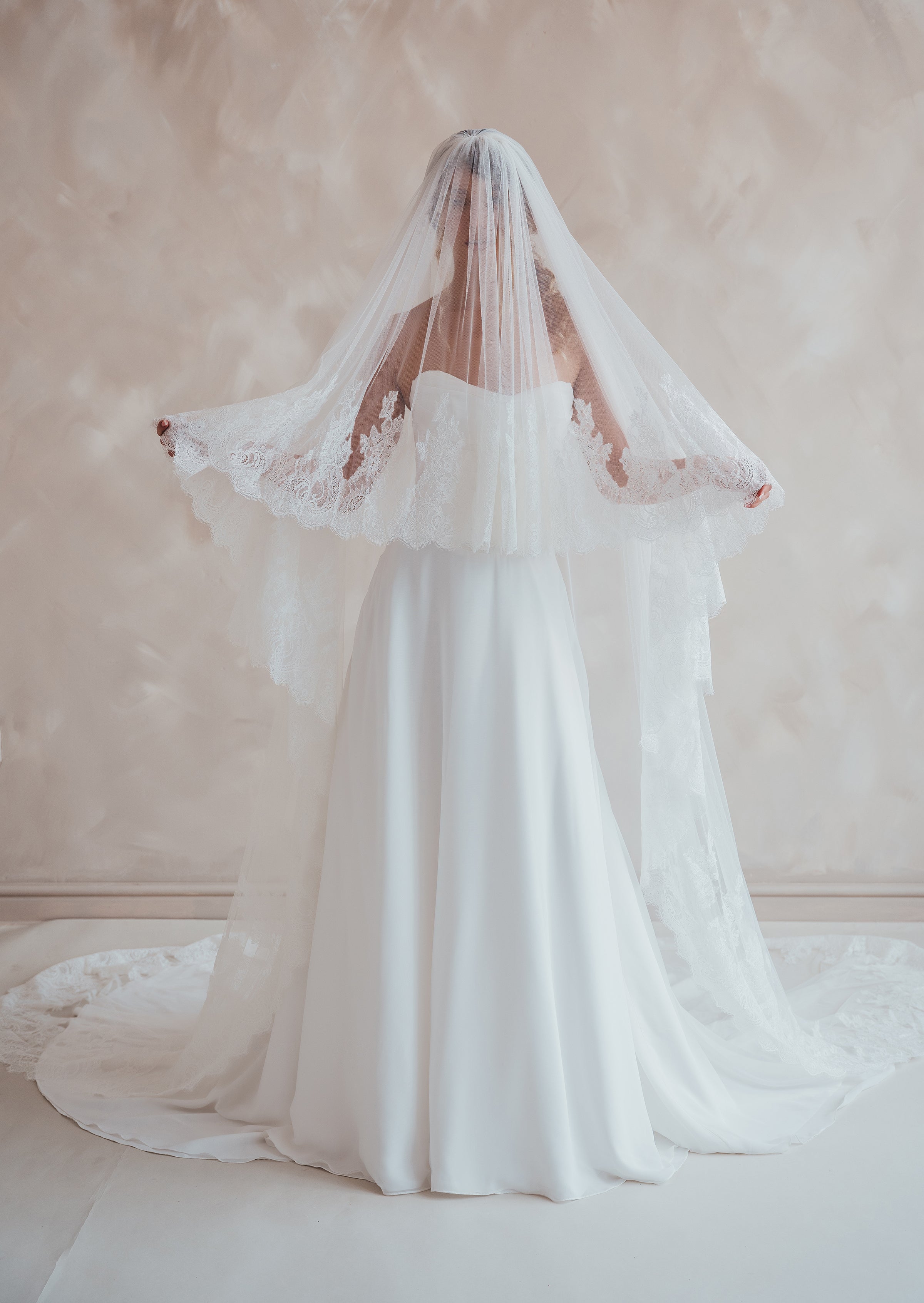 Bride wearing the Penelope two-tier Chantilly lace veil with eyelash edging.